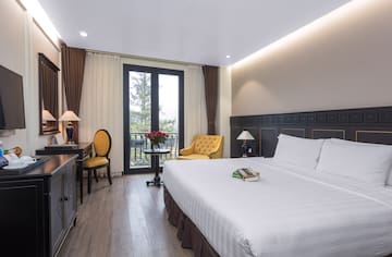 a room with a bed and a table and chairs