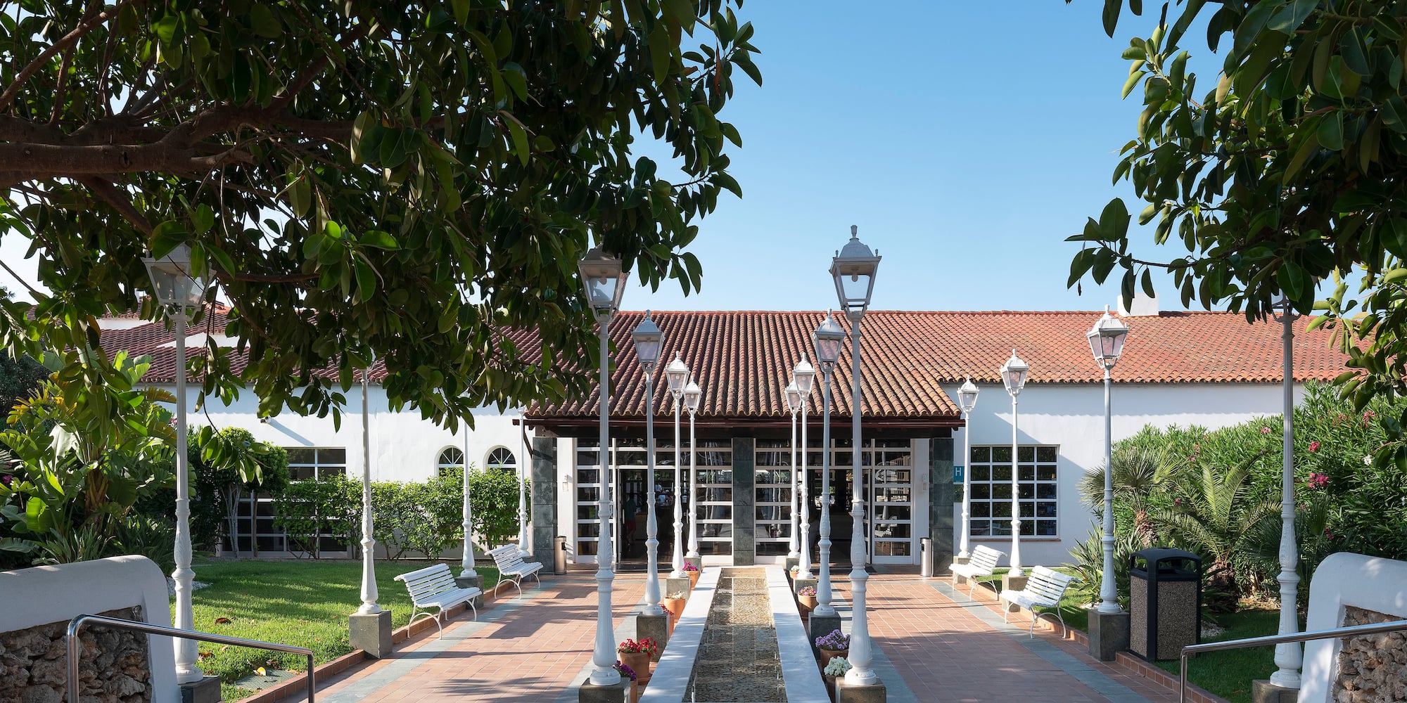 a building with a fountain and trees
