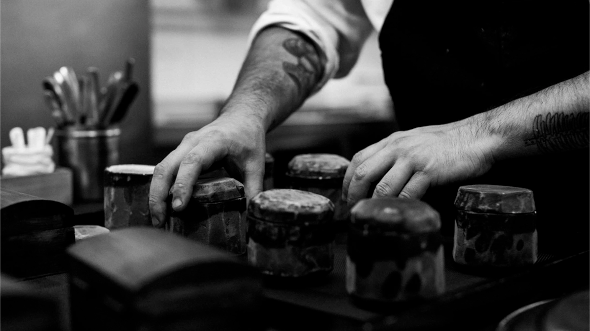 a person holding jars of food