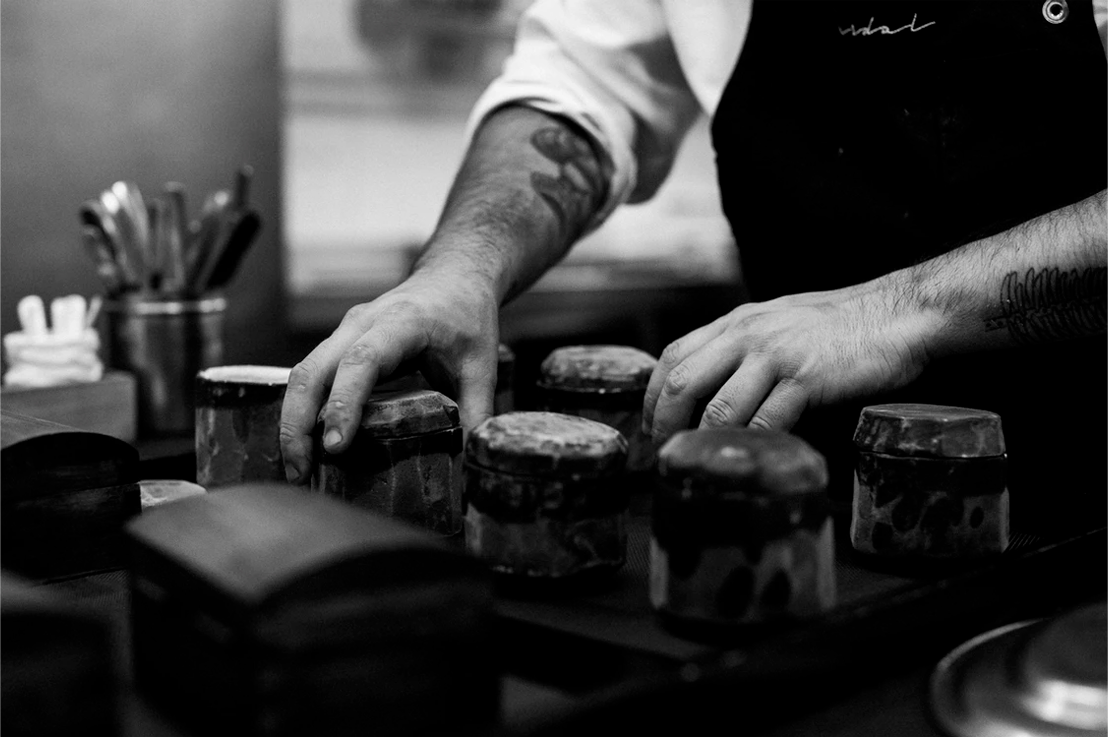 a person holding jars of food