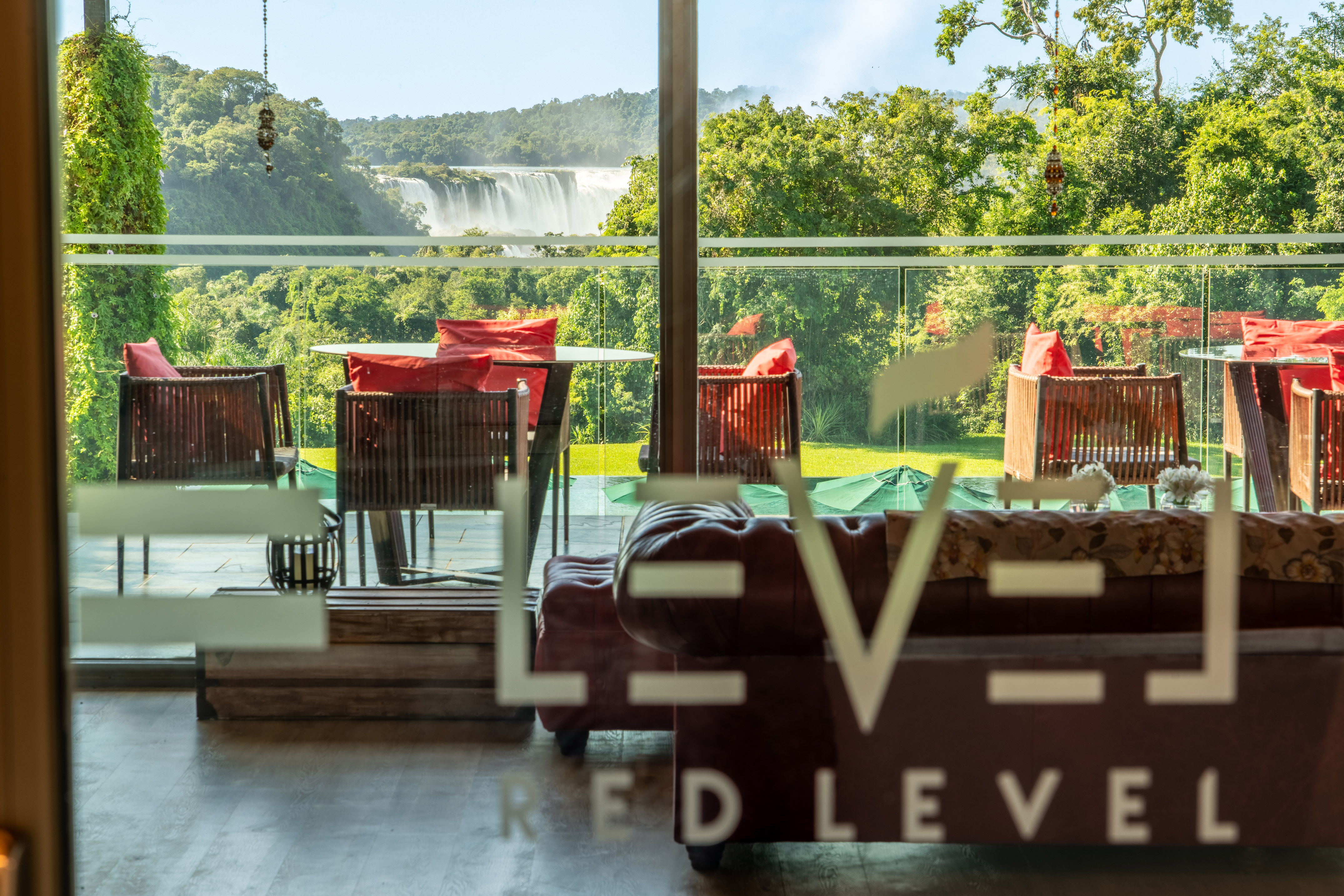 a room with a view of a waterfall and chairs