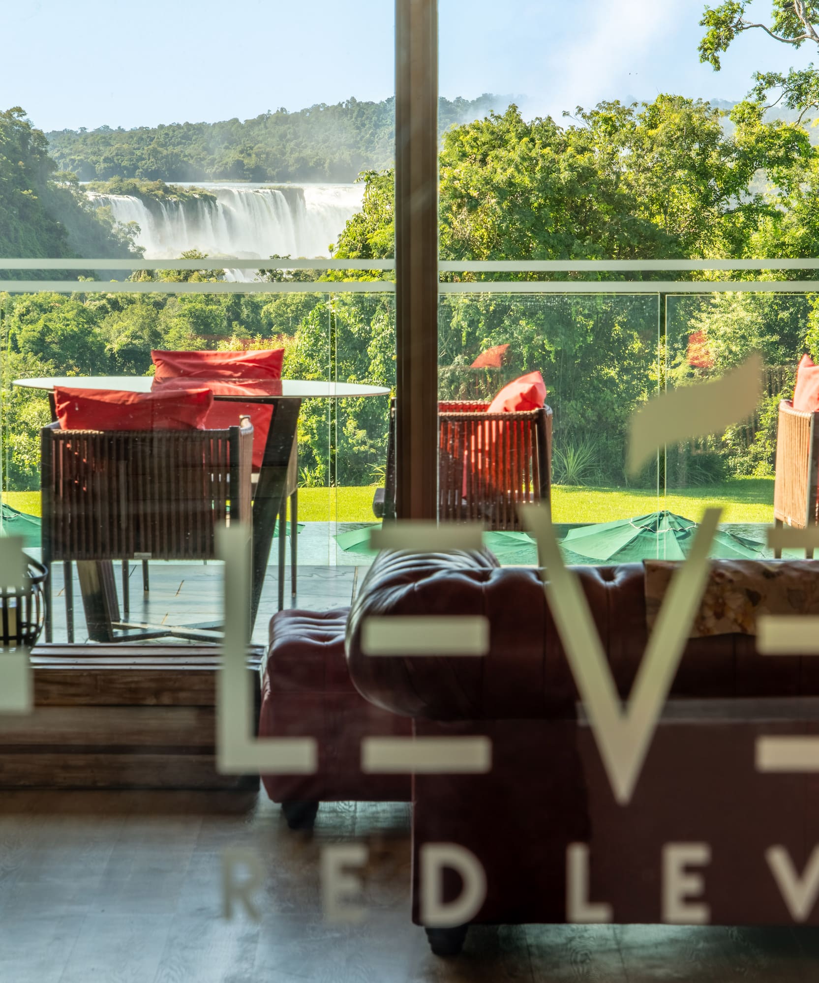 a room with a view of a waterfall and chairs