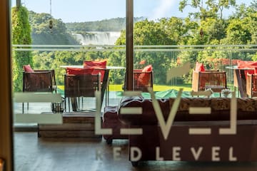a room with a view of a waterfall and chairs