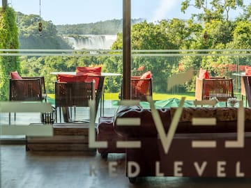 a room with a view of a waterfall and chairs