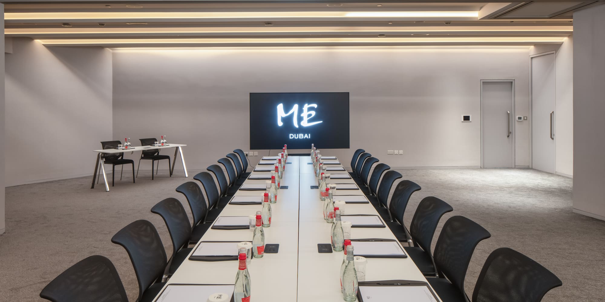 a conference room with a large screen