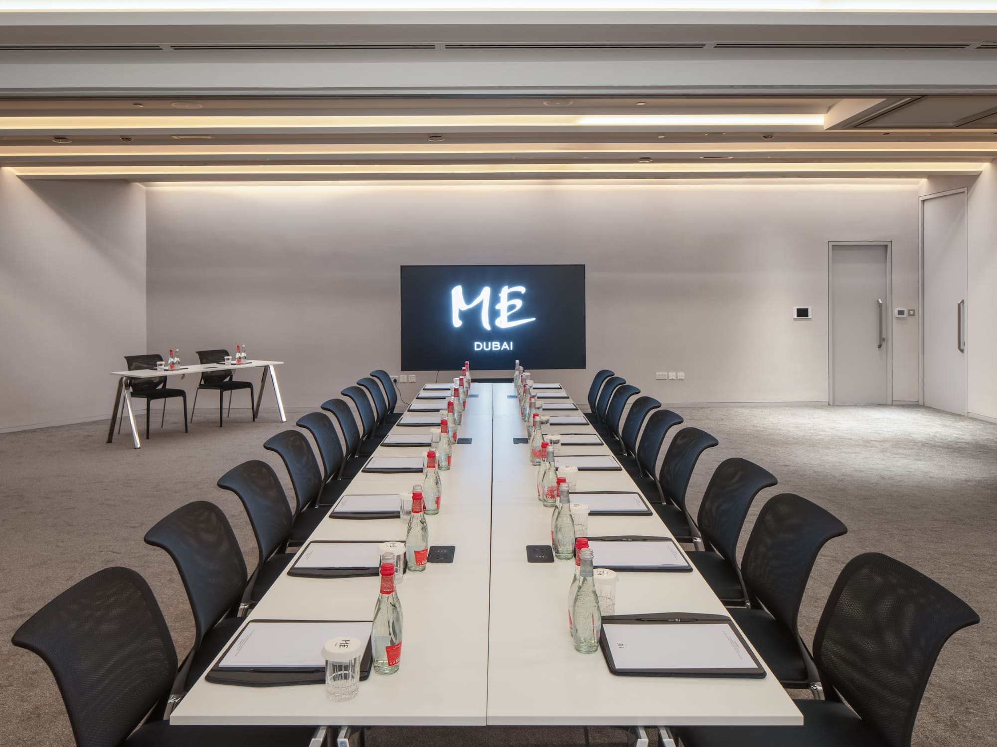 a conference room with a large screen