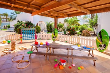 a picnic table with toys on a patio
