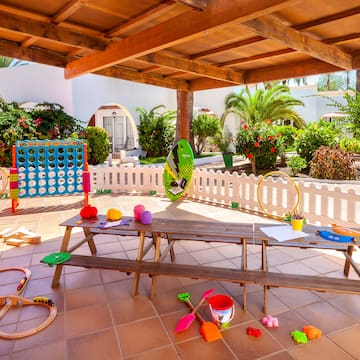 a picnic table with toys on a patio