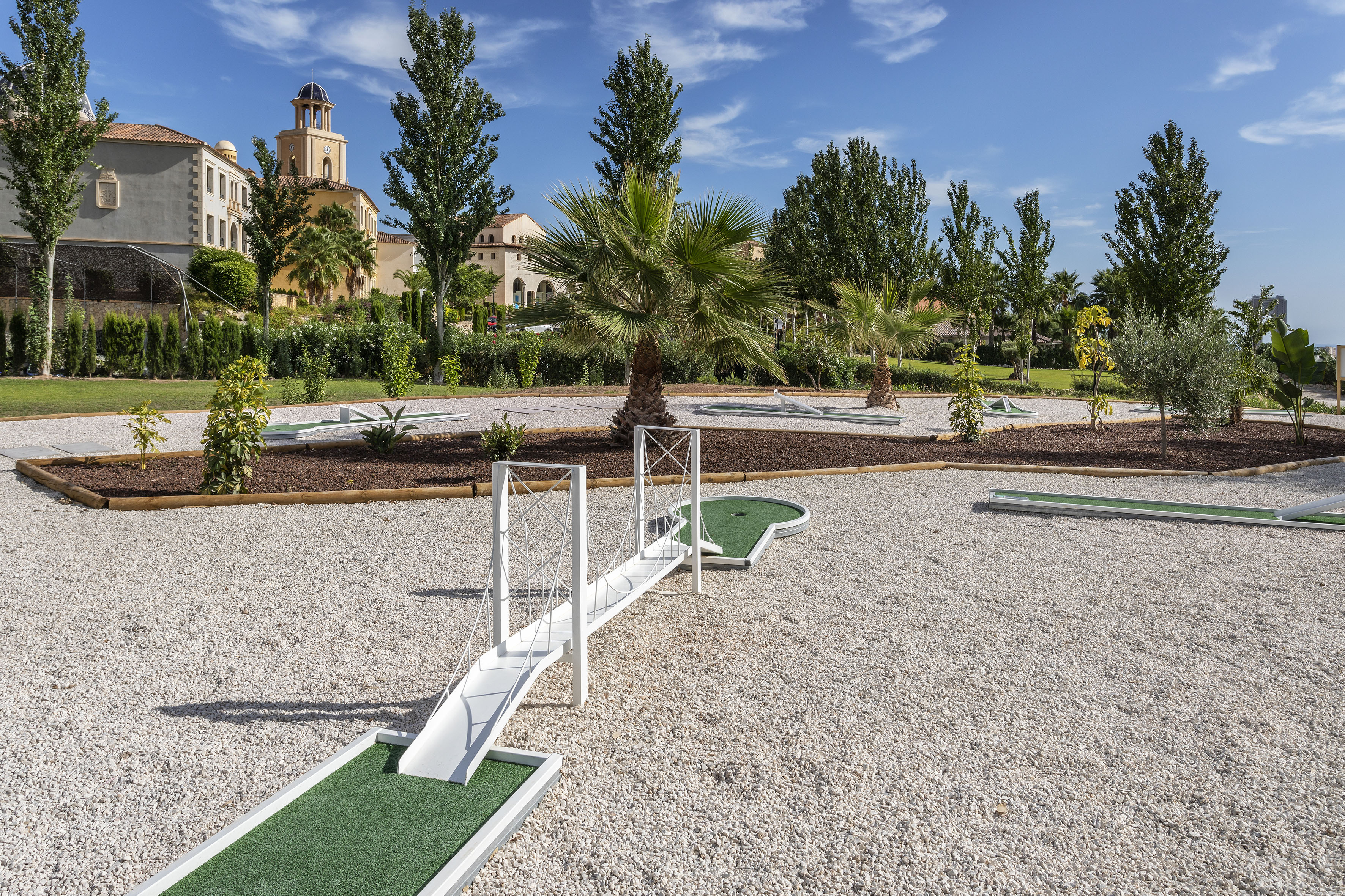 a mini golf course with a bridge and palm trees