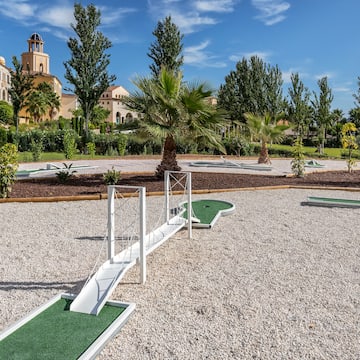a mini golf course with a bridge and palm trees