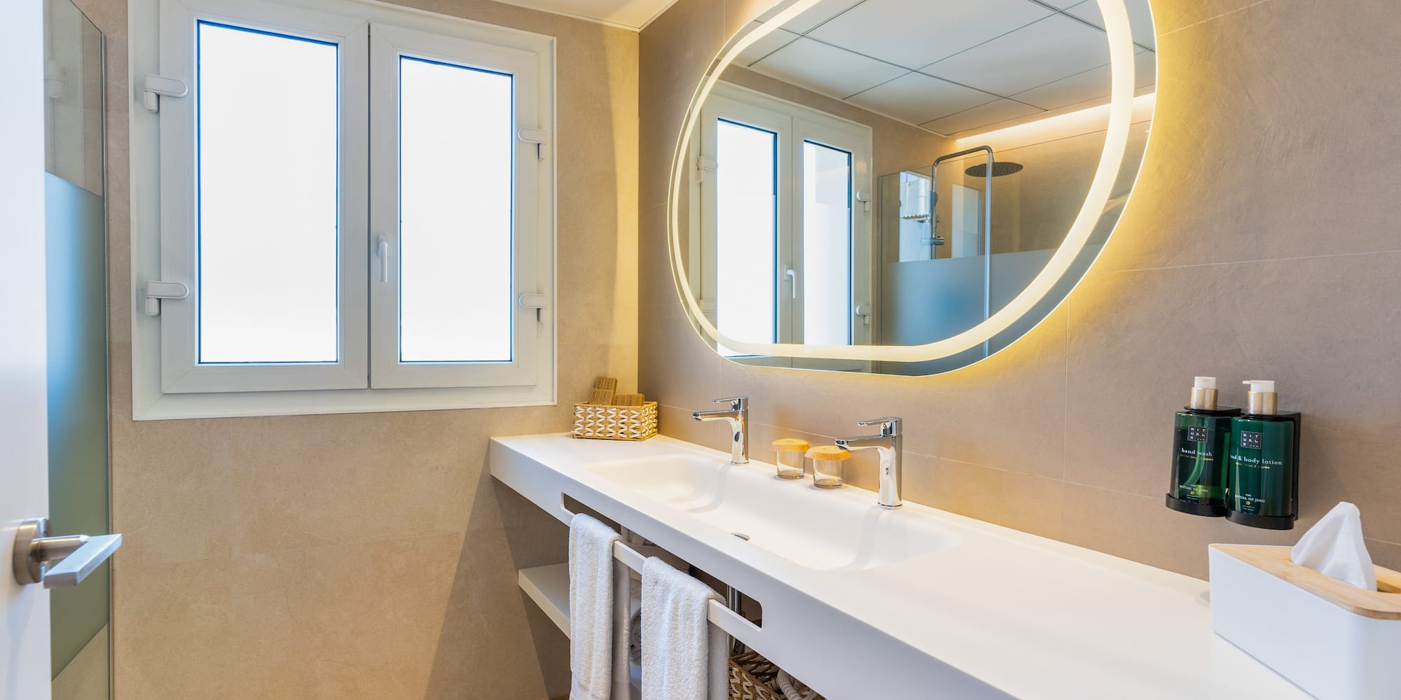 a bathroom with a large round mirror