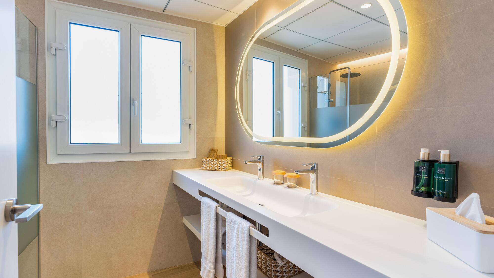 a bathroom with a large round mirror