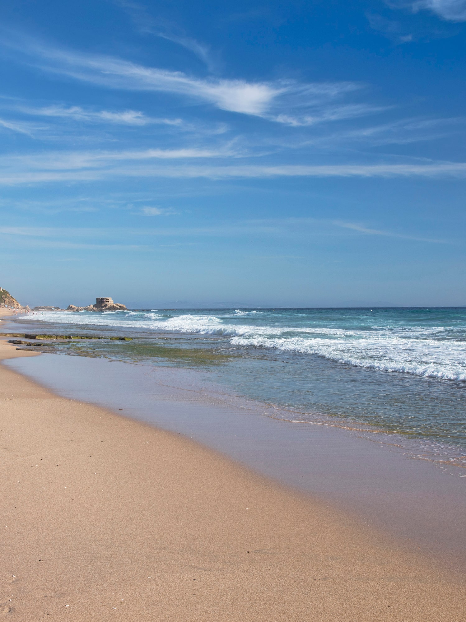 a beach with waves crashing on the shore