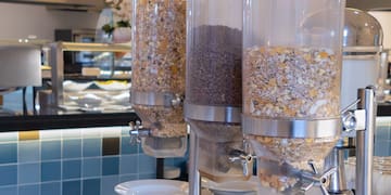 a group of cereals in containers on a table