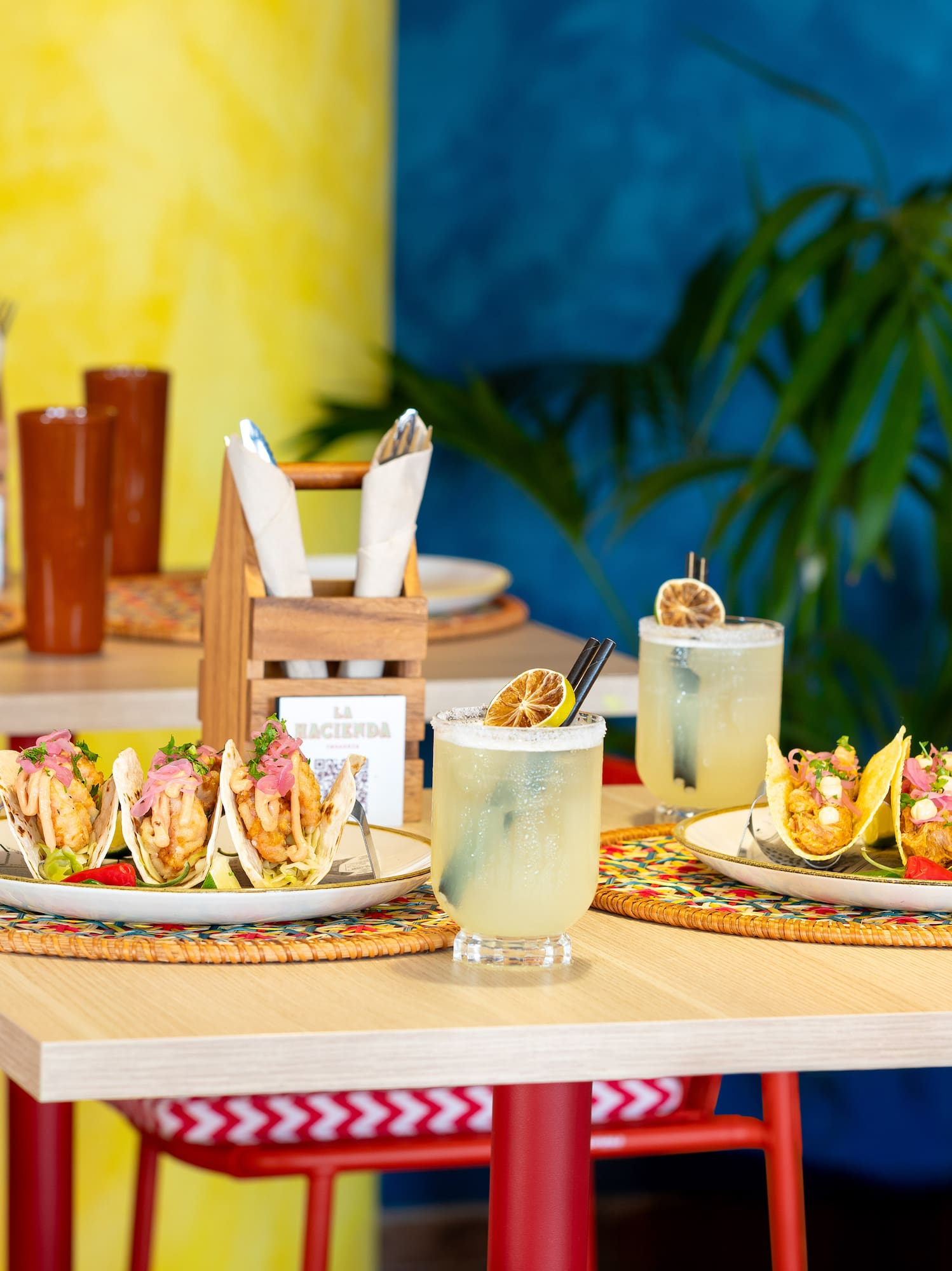a table with tacos and drinks