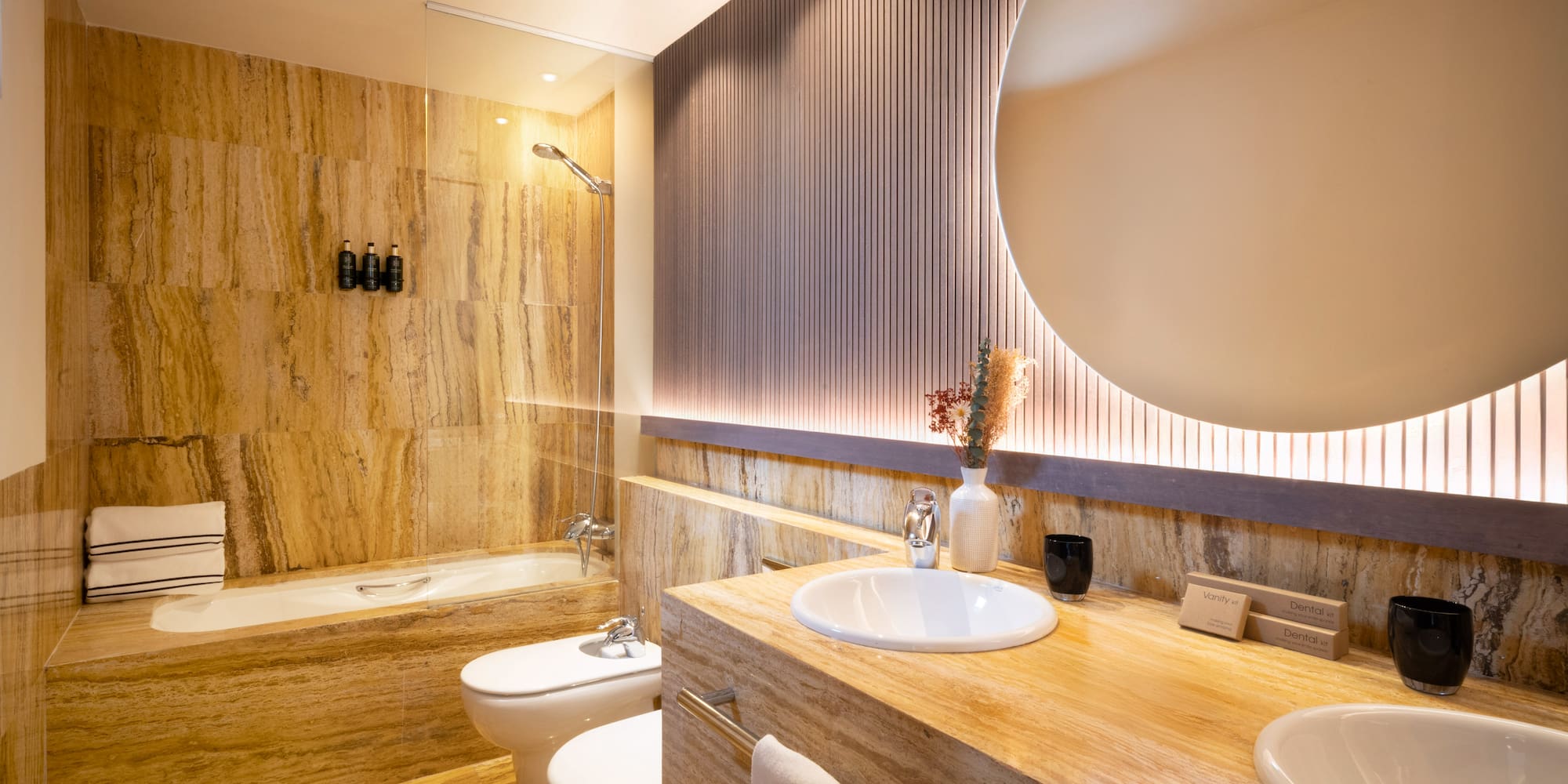 a bathroom with a round mirror and a marble counter top