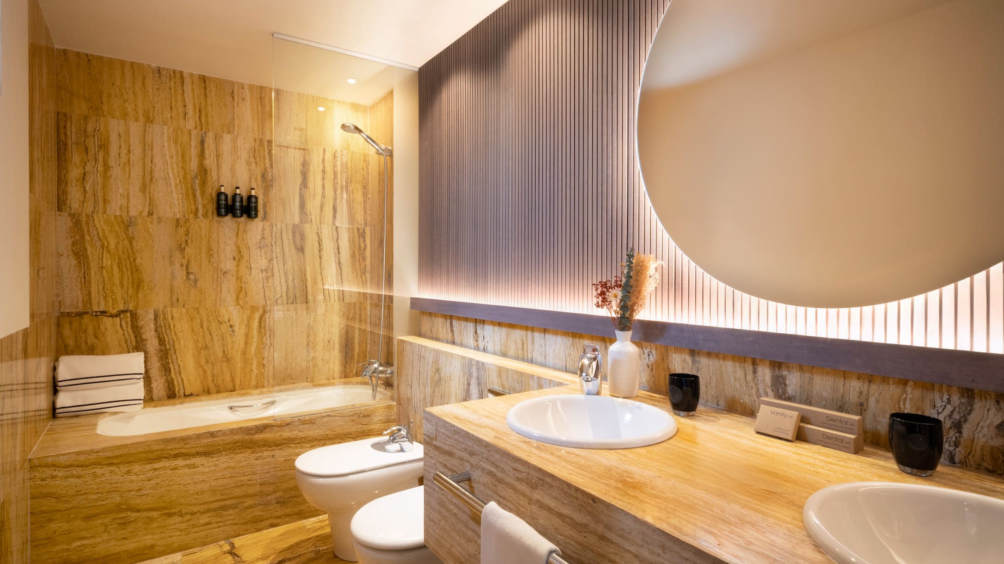 a bathroom with a large round mirror