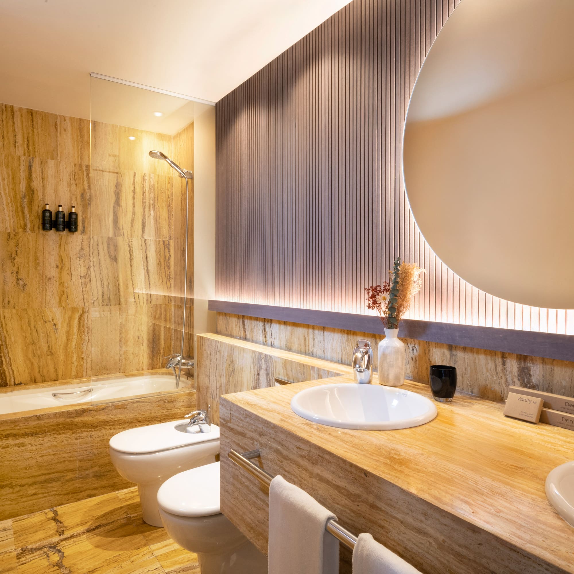 a bathroom with a large round mirror