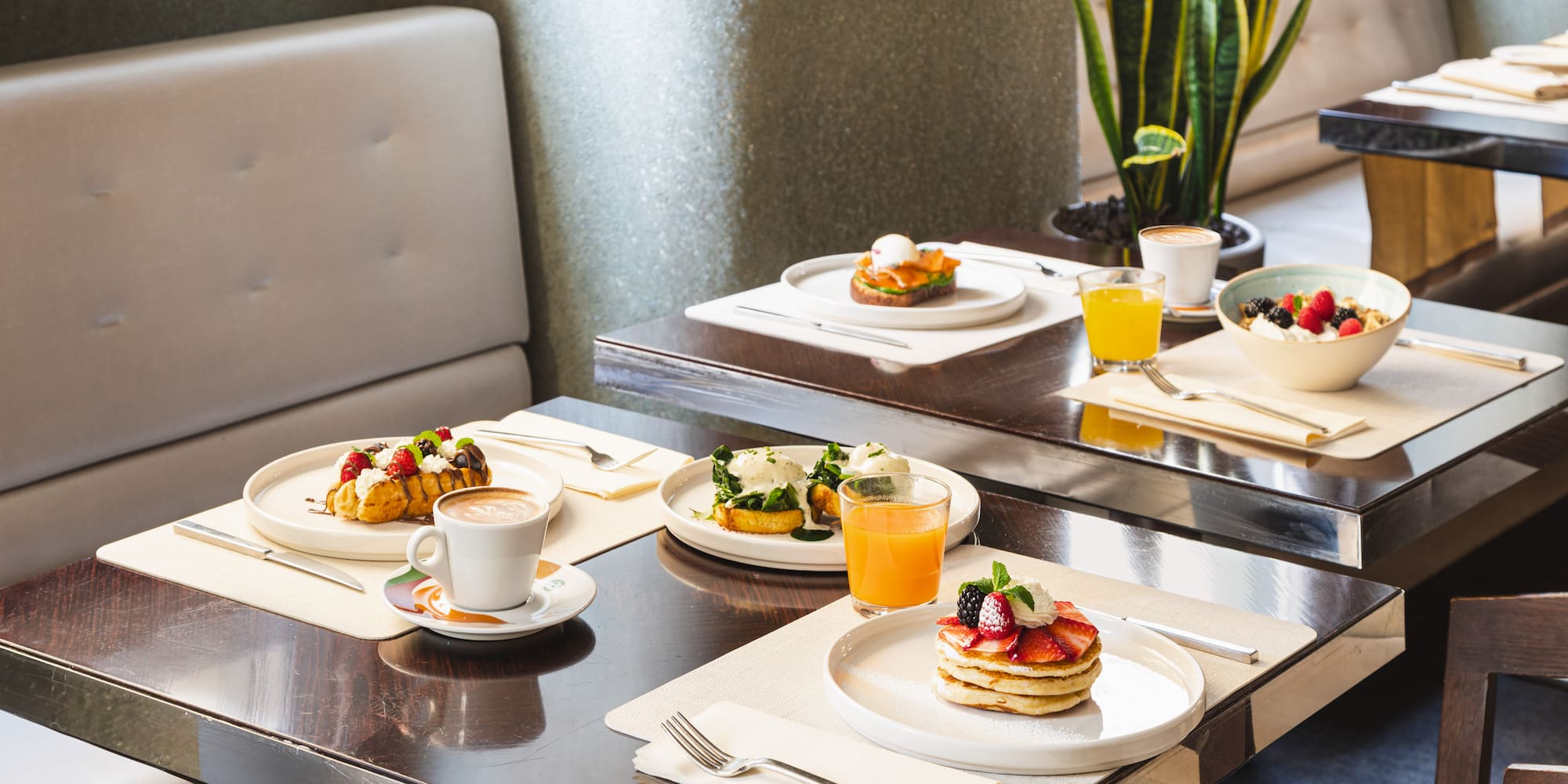 a table with plates of food and drinks