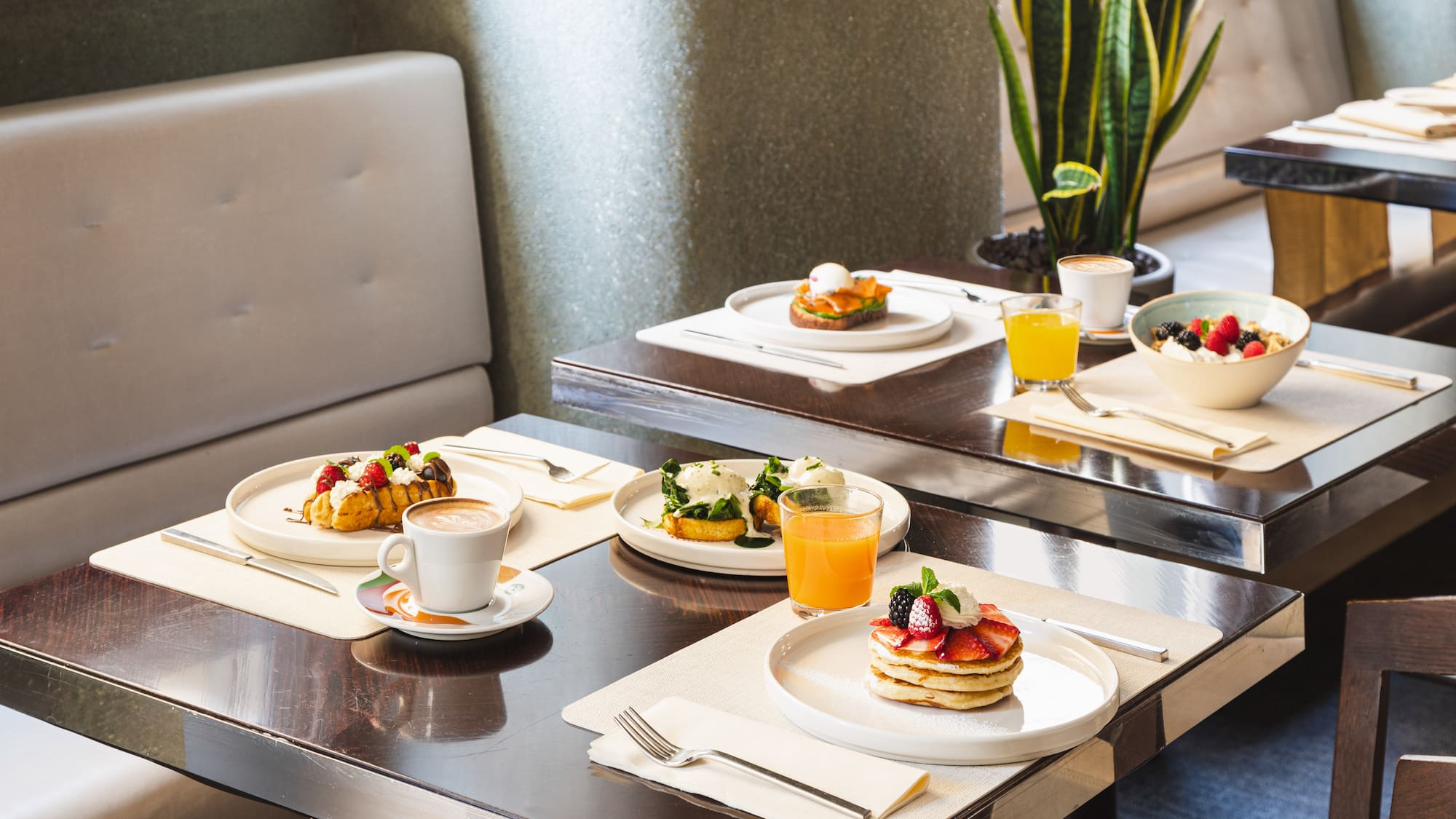 a table with plates of food and drinks