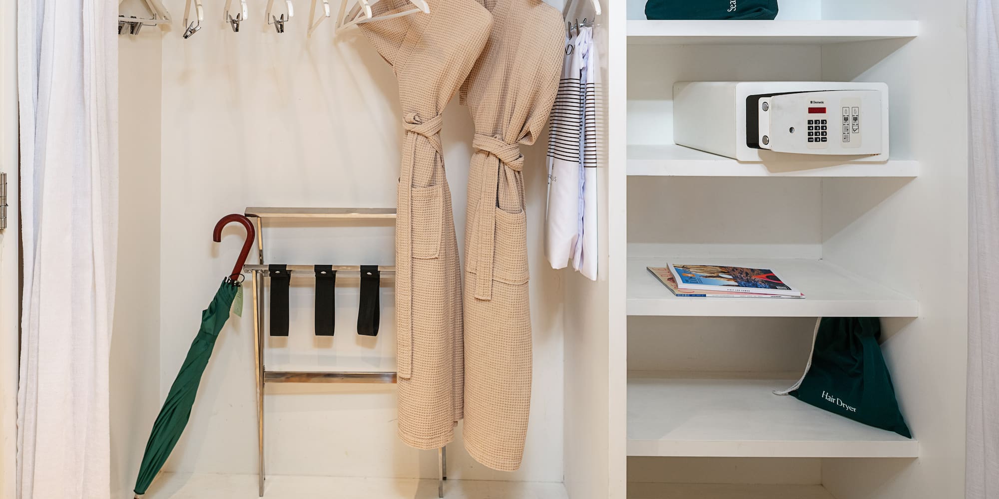 a closet with white shelves and white robe on swingers