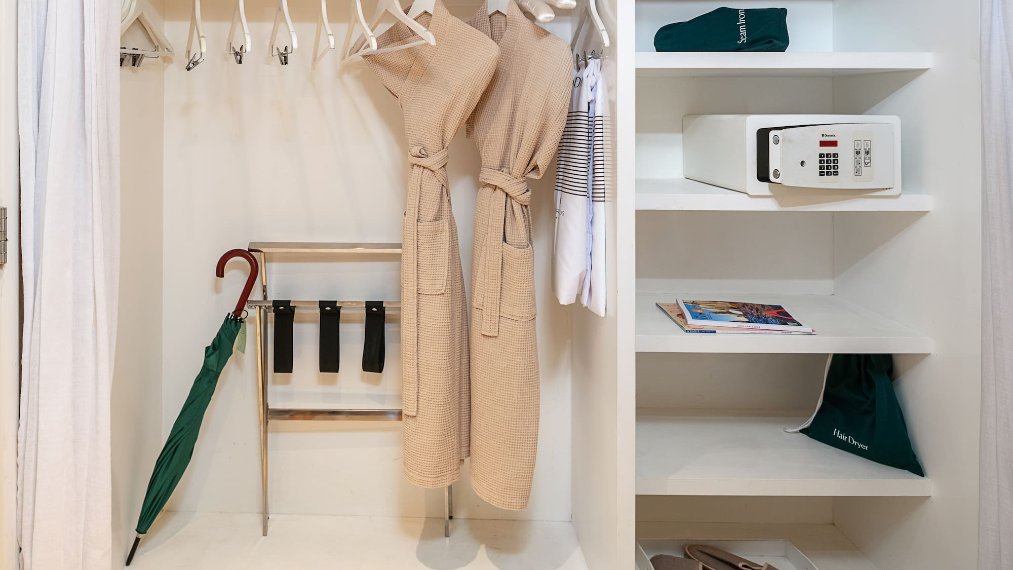 a closet with white shelves and white robe on swingers