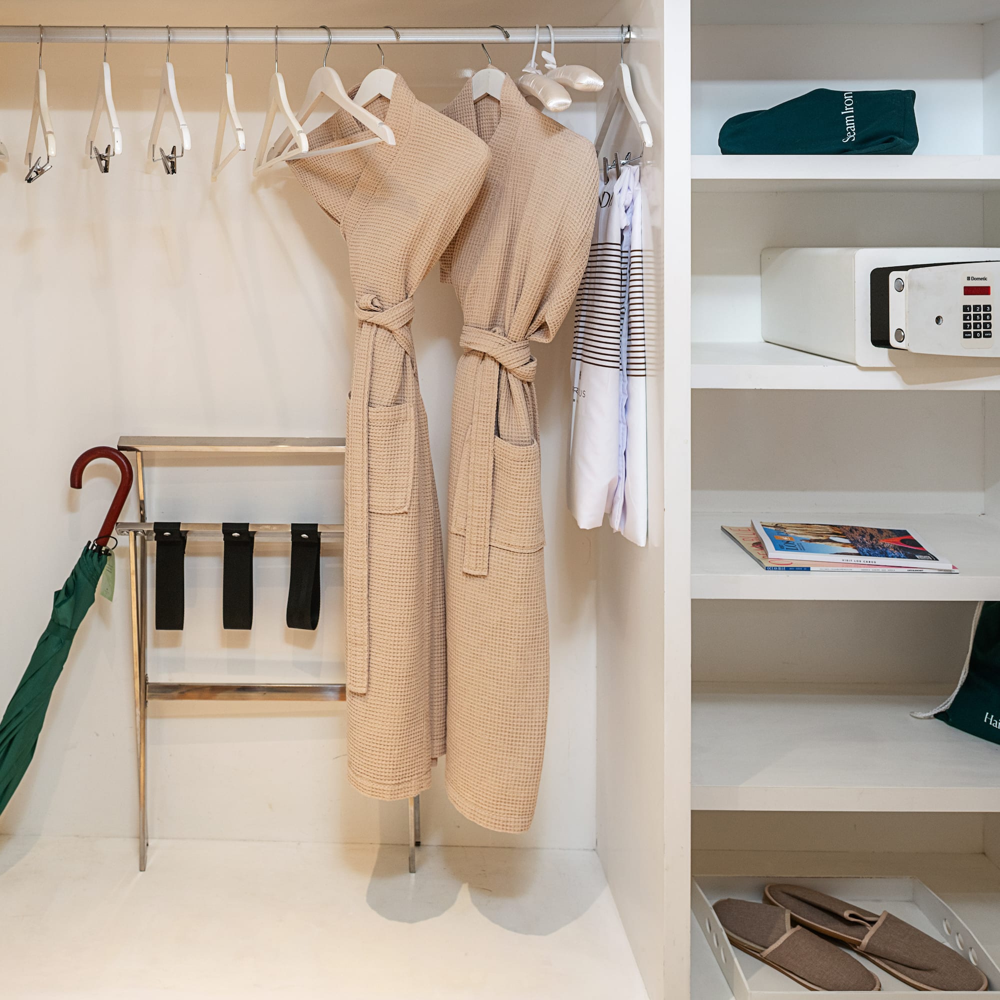 a closet with white shelves and white robe on swingers