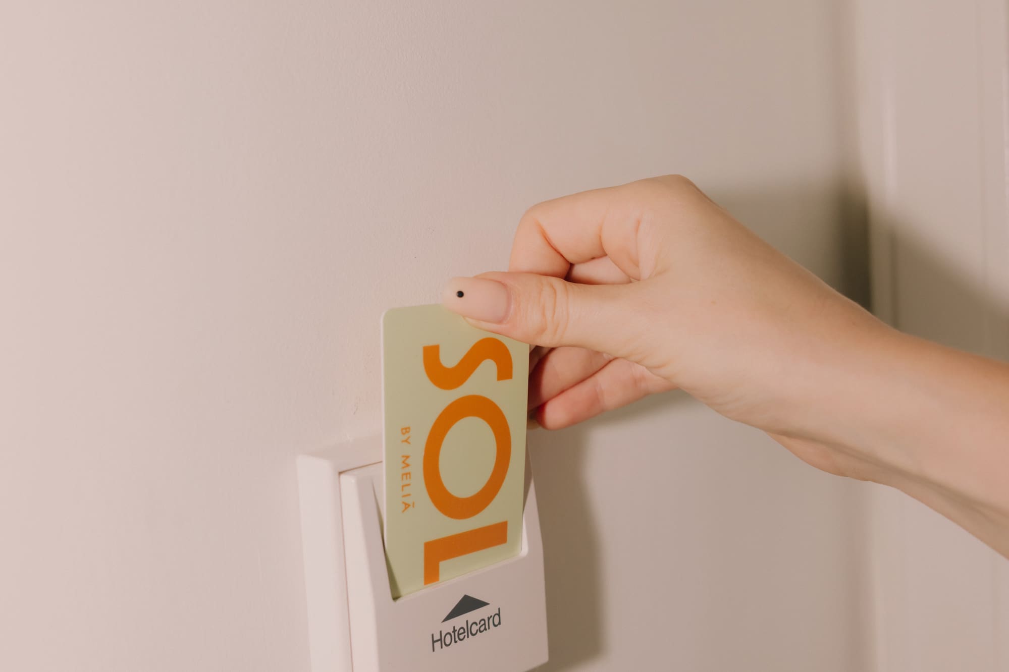 a hand holding a card in a white box