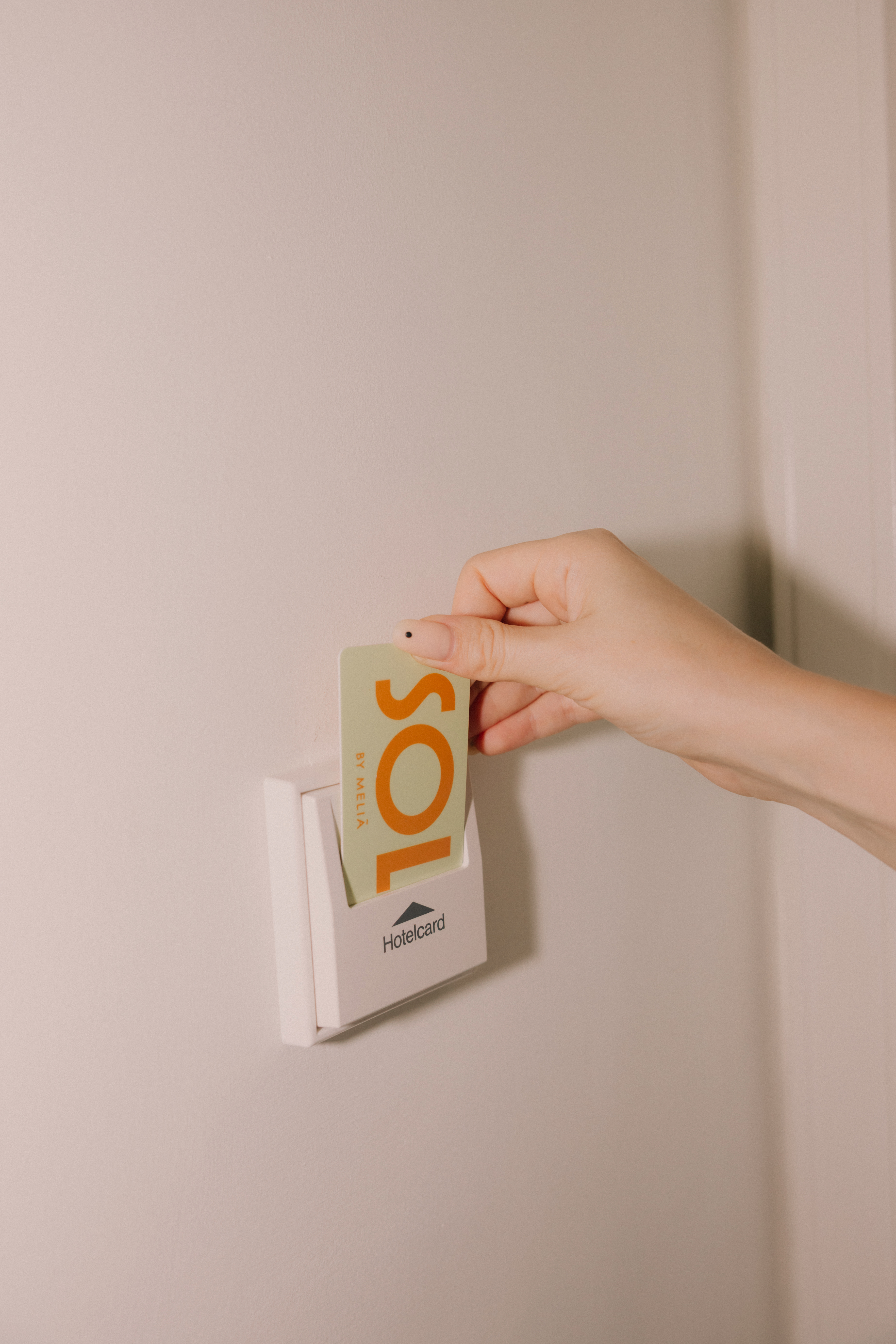 a hand holding a card in a white box