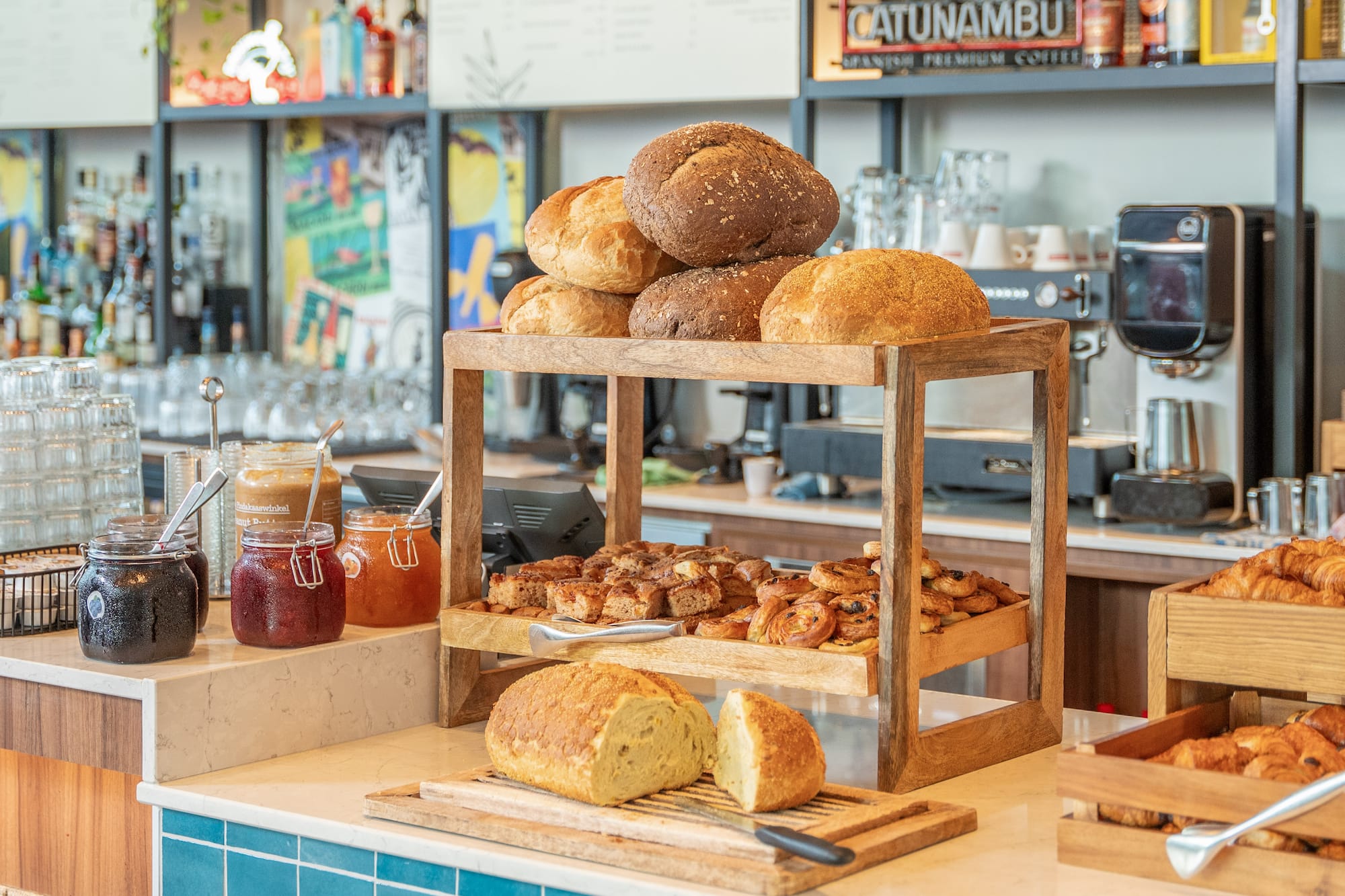 Cafe breakfast bar with artisan bread, pastries, and jams.
