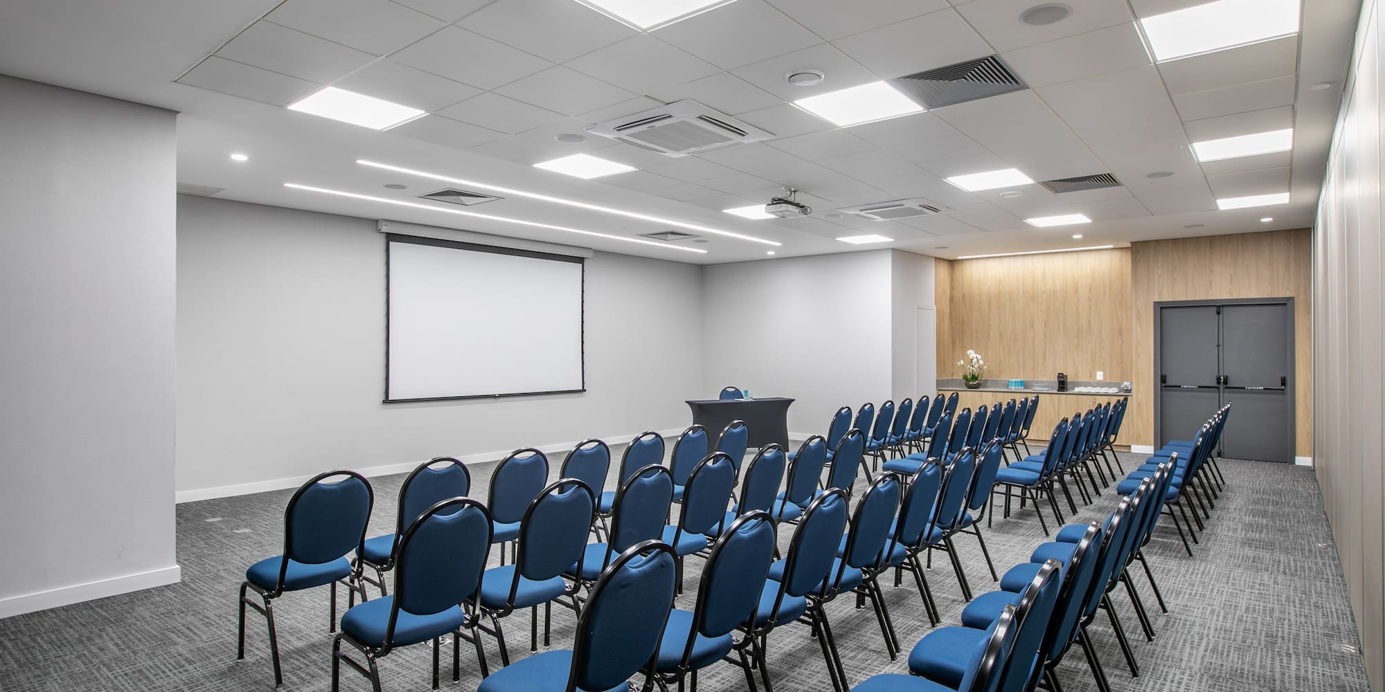 a room with rows of blue chairs