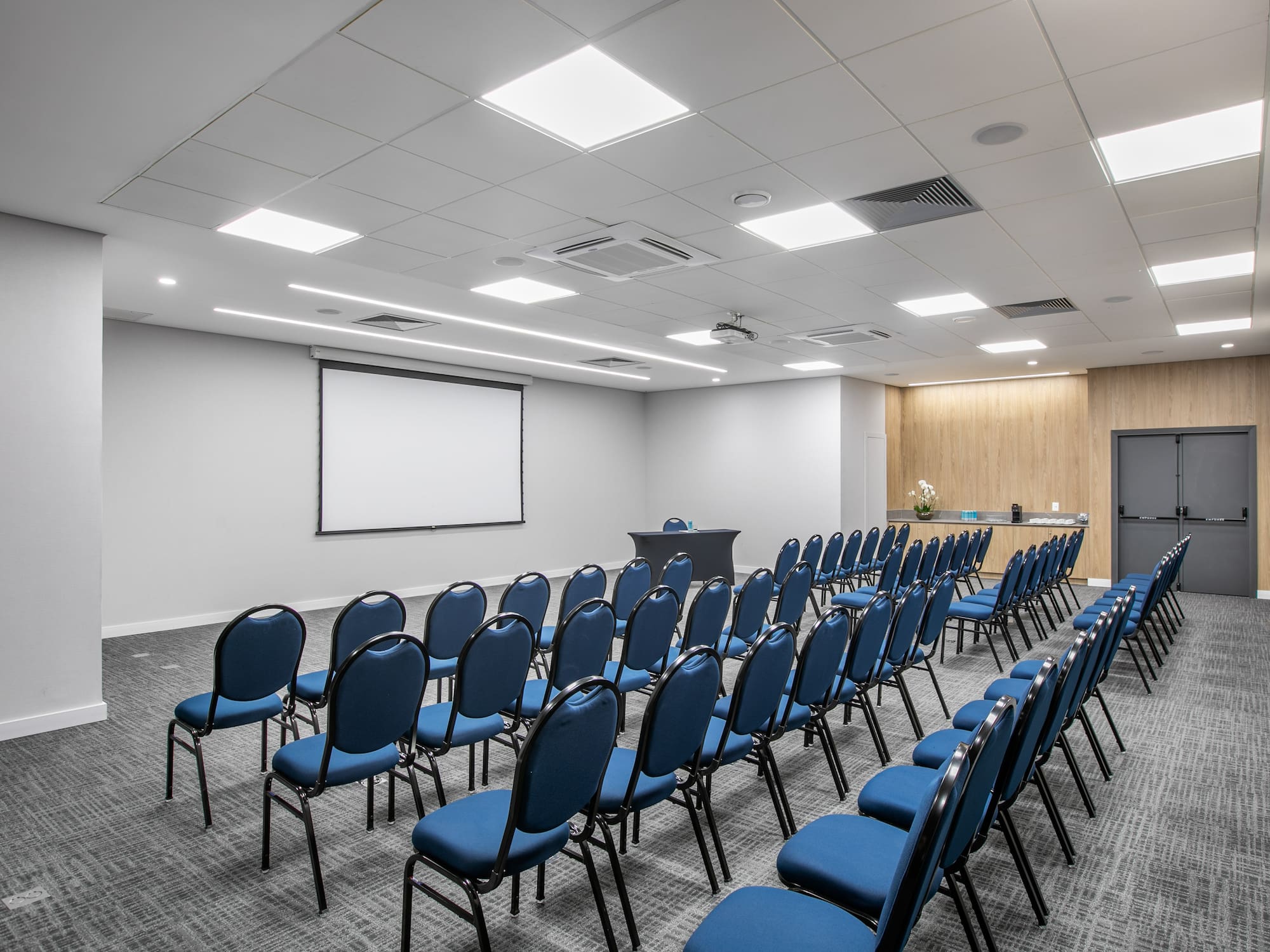 a room with rows of blue chairs