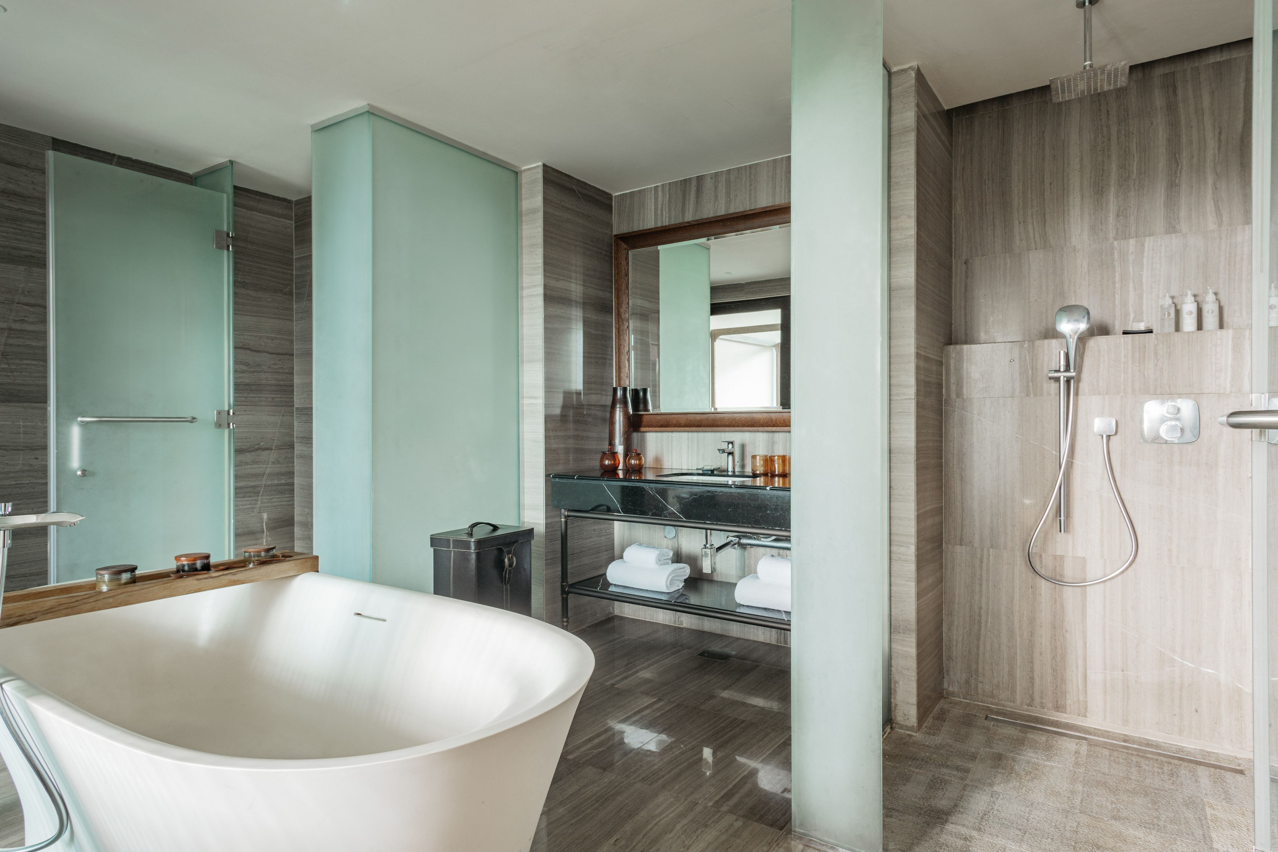 Modern luxury bathroom with freestanding tub, marble vanity, and walk-in shower.