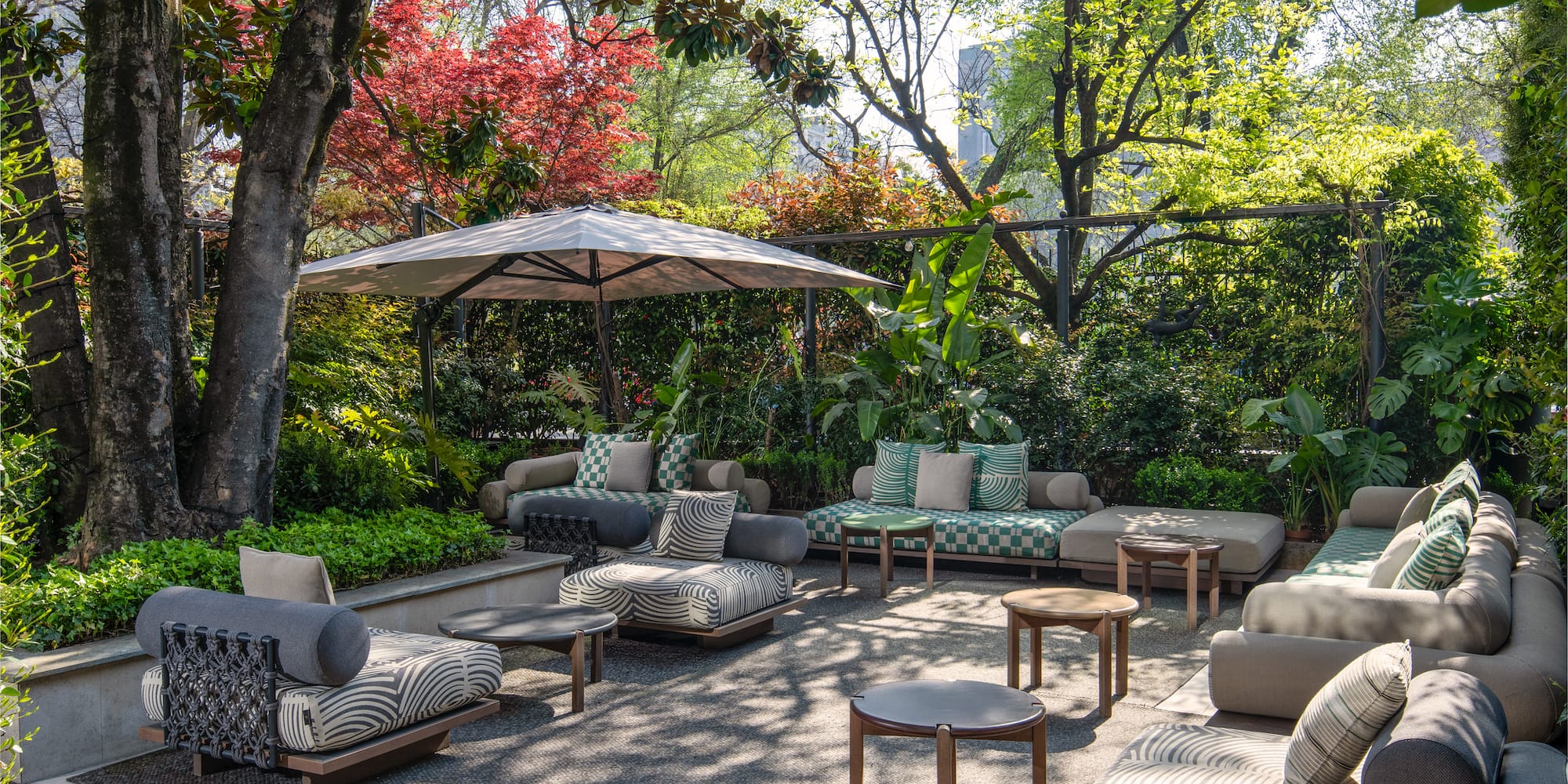 a patio area with furniture and umbrella