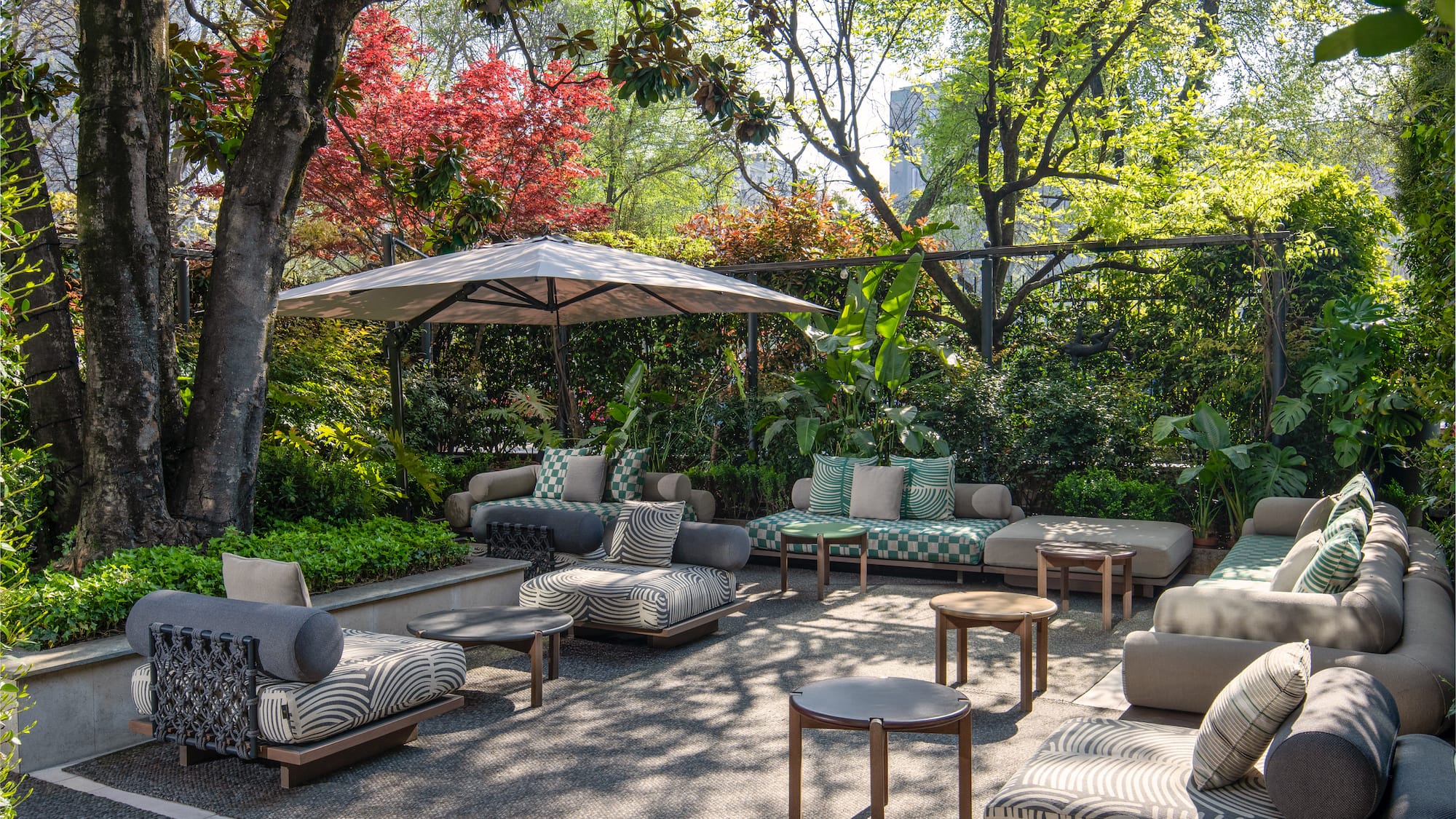 a patio area with furniture and umbrella