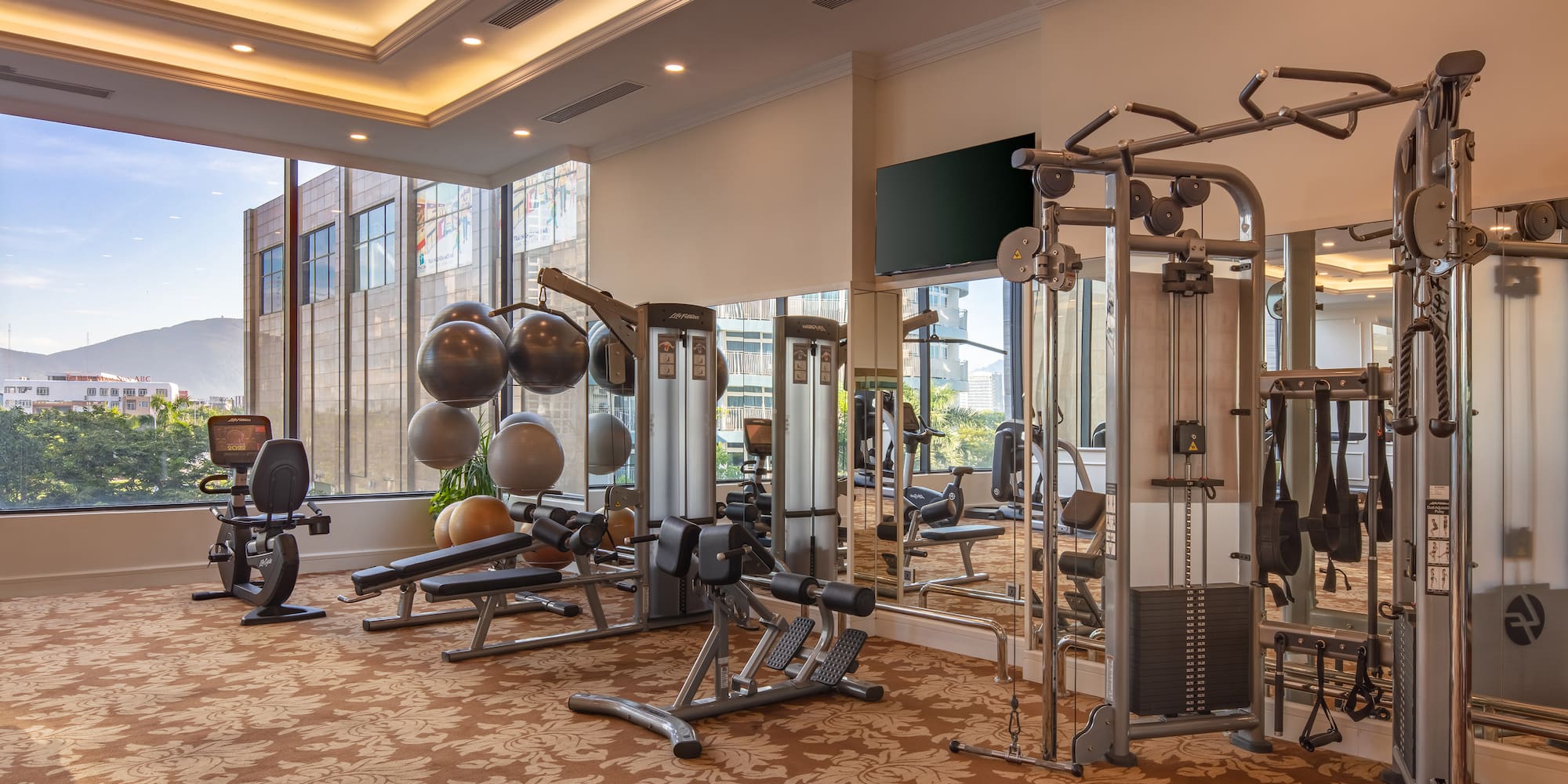 a room with exercise equipment and a mirror