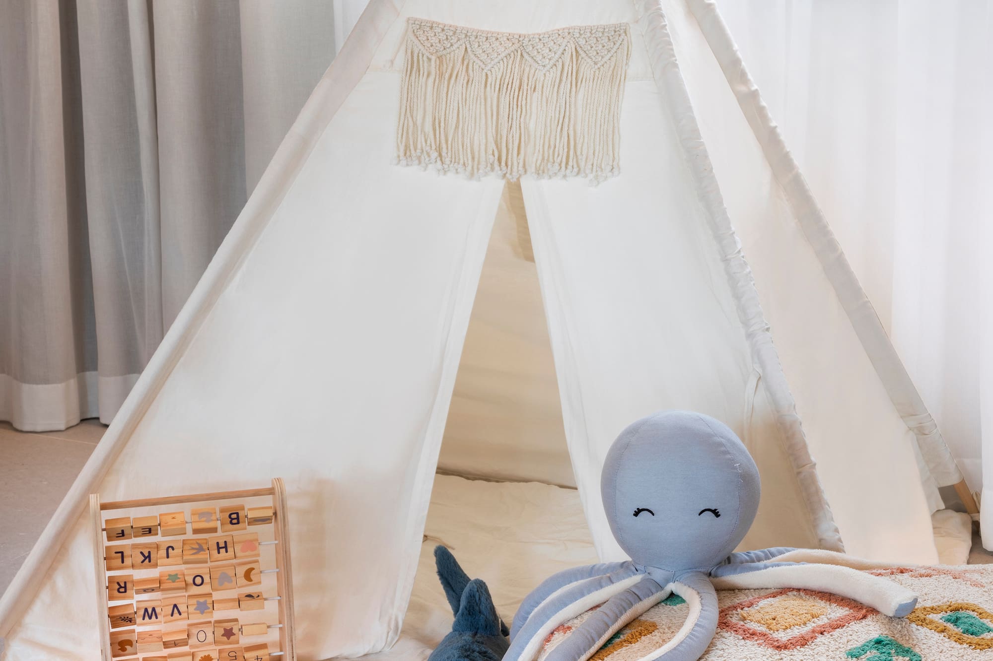 a teepee with toys and a stuffed animal