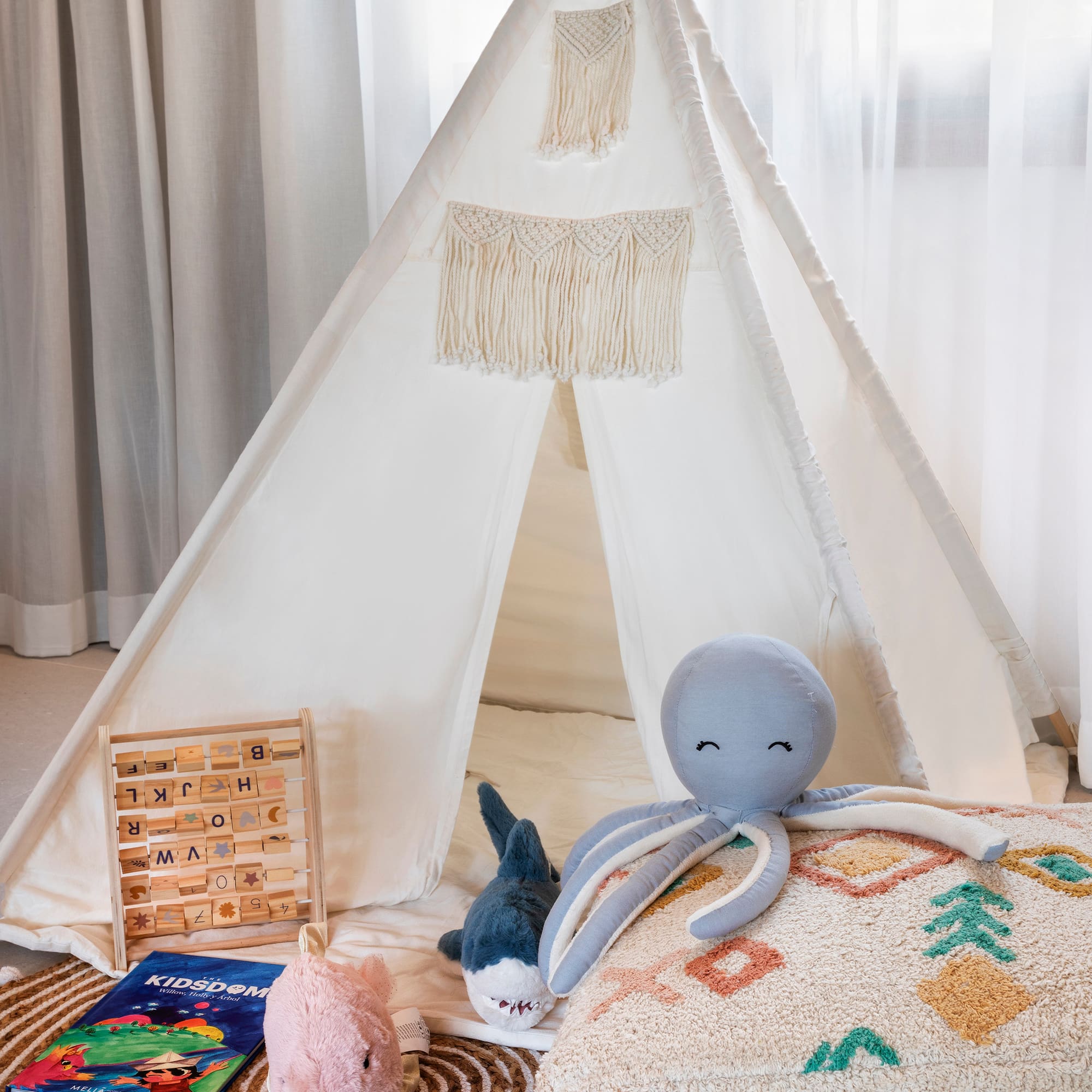 a teepee with toys and a stuffed animal