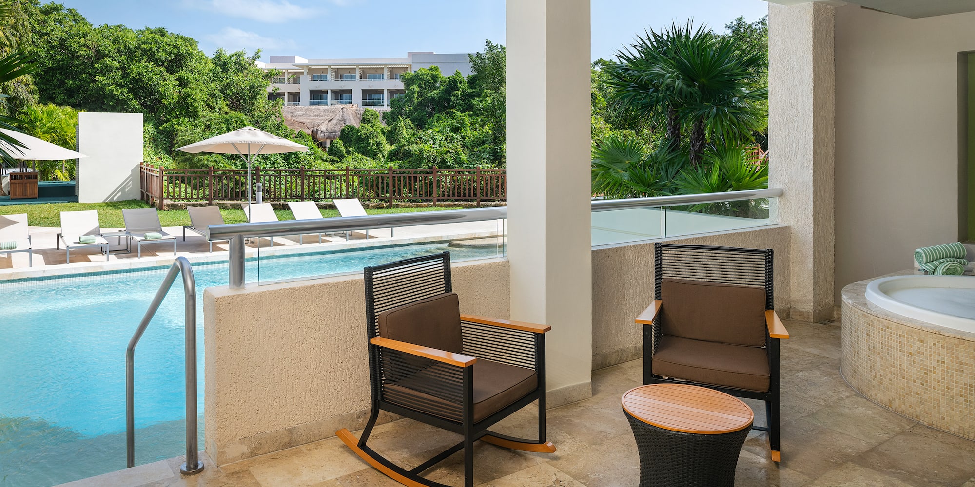 a patio with chairs and a pool