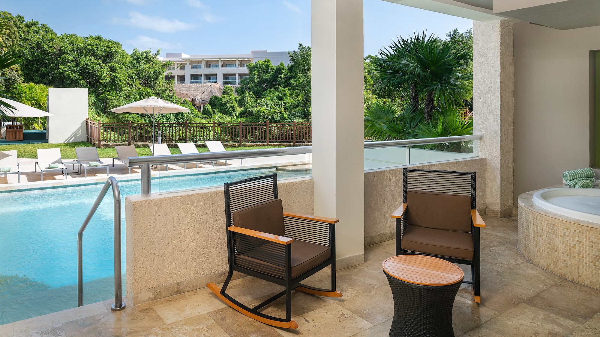 a patio with chairs and a pool