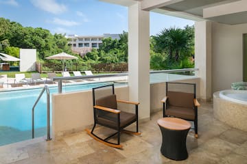 a patio with chairs and a pool