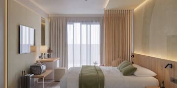 a bedroom with a bed and a mirror