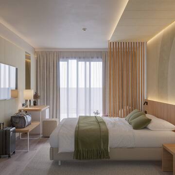 a bedroom with a bed and a mirror