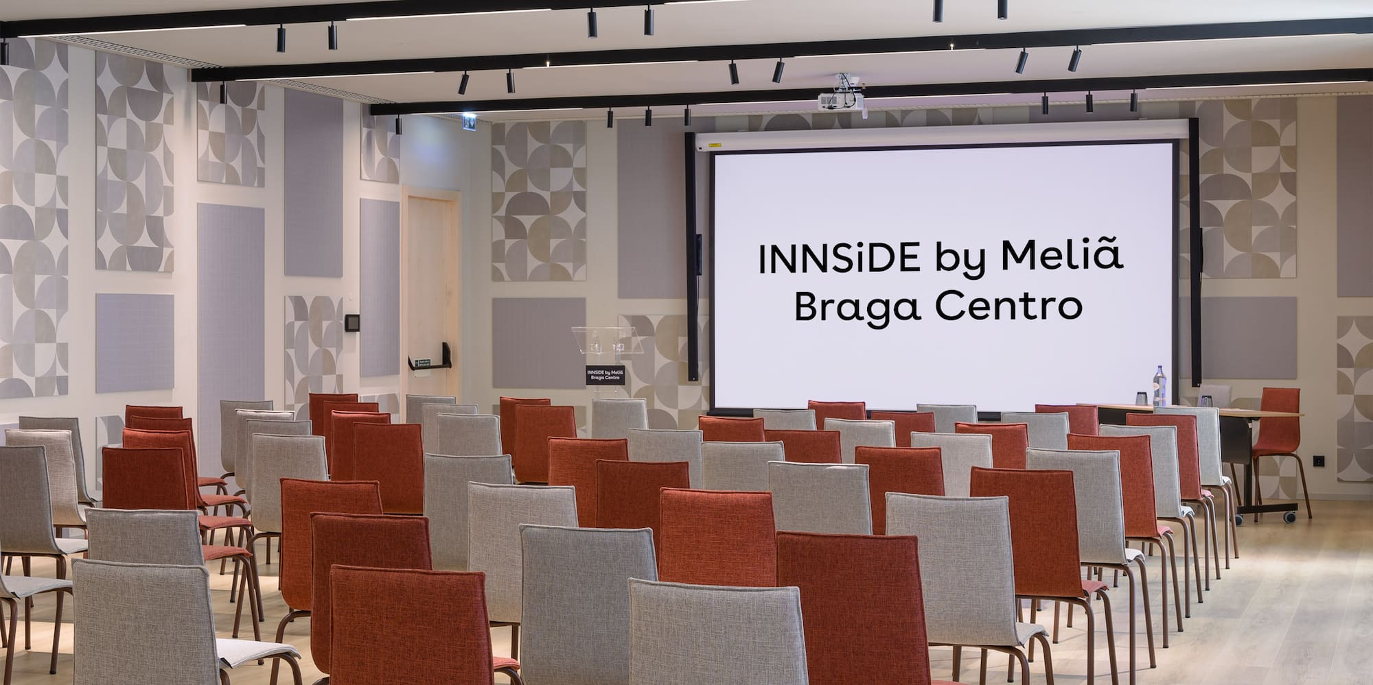 a room with chairs and a projector screen