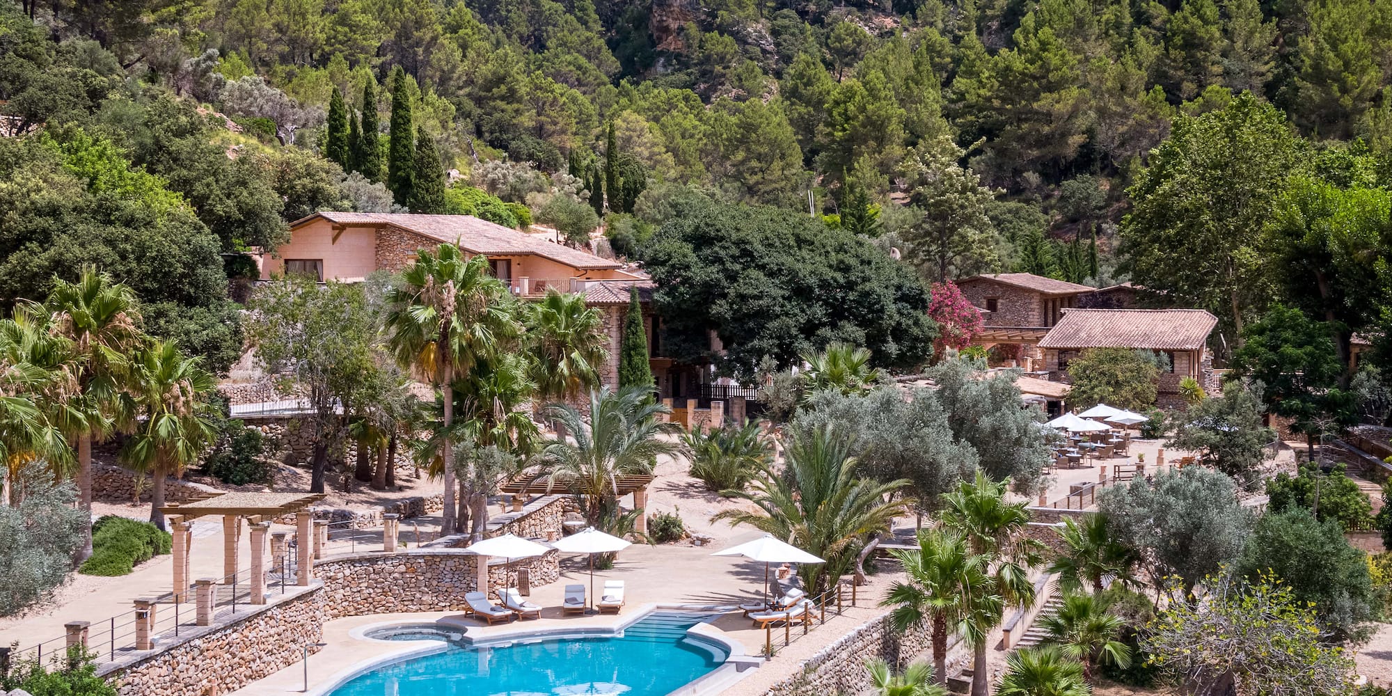 a pool surrounded by trees and buildings