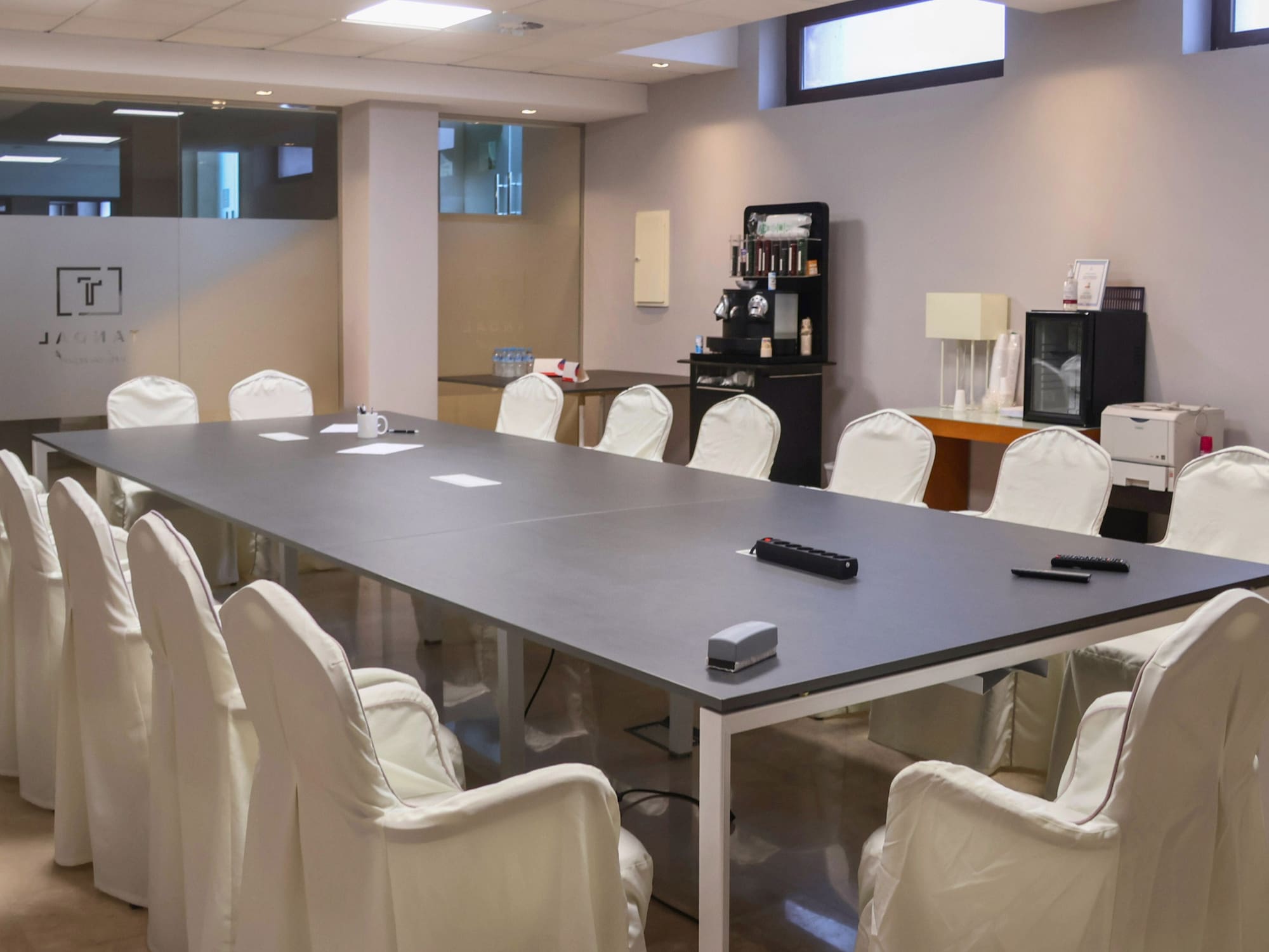a conference room with a table and chairs