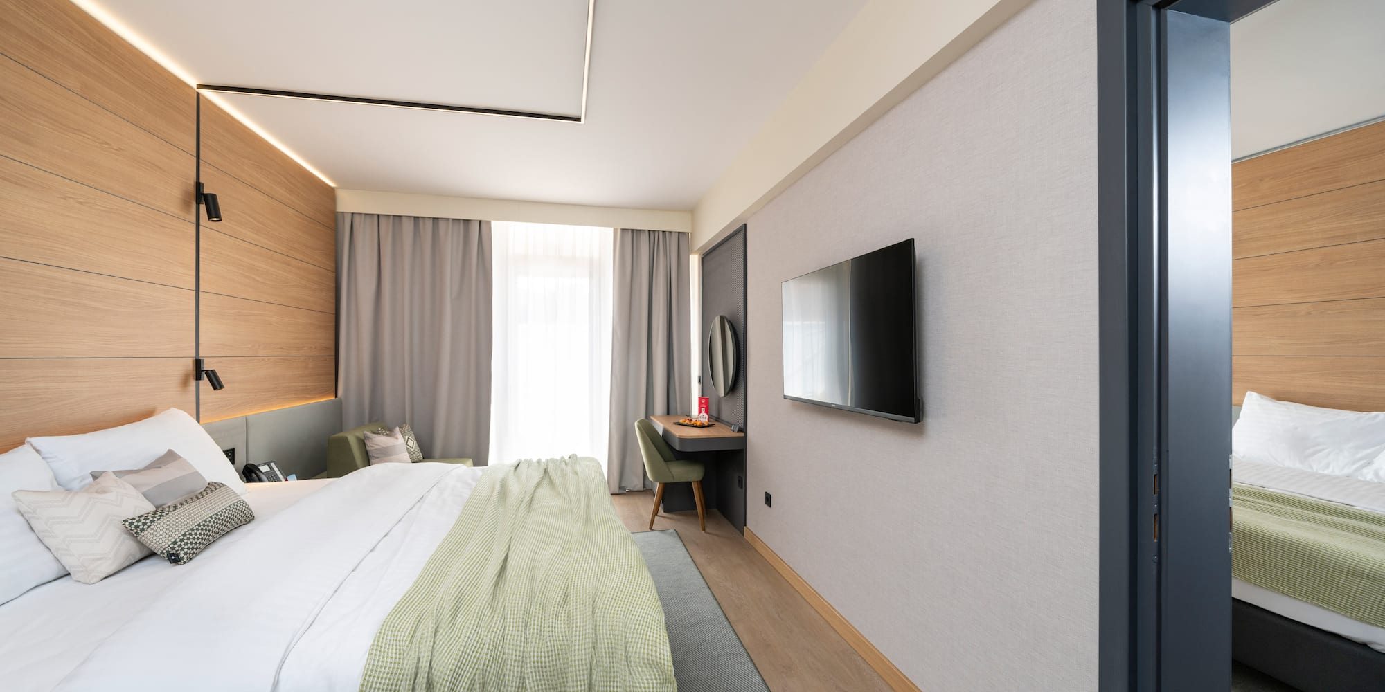 a bedroom with a tv and a bed