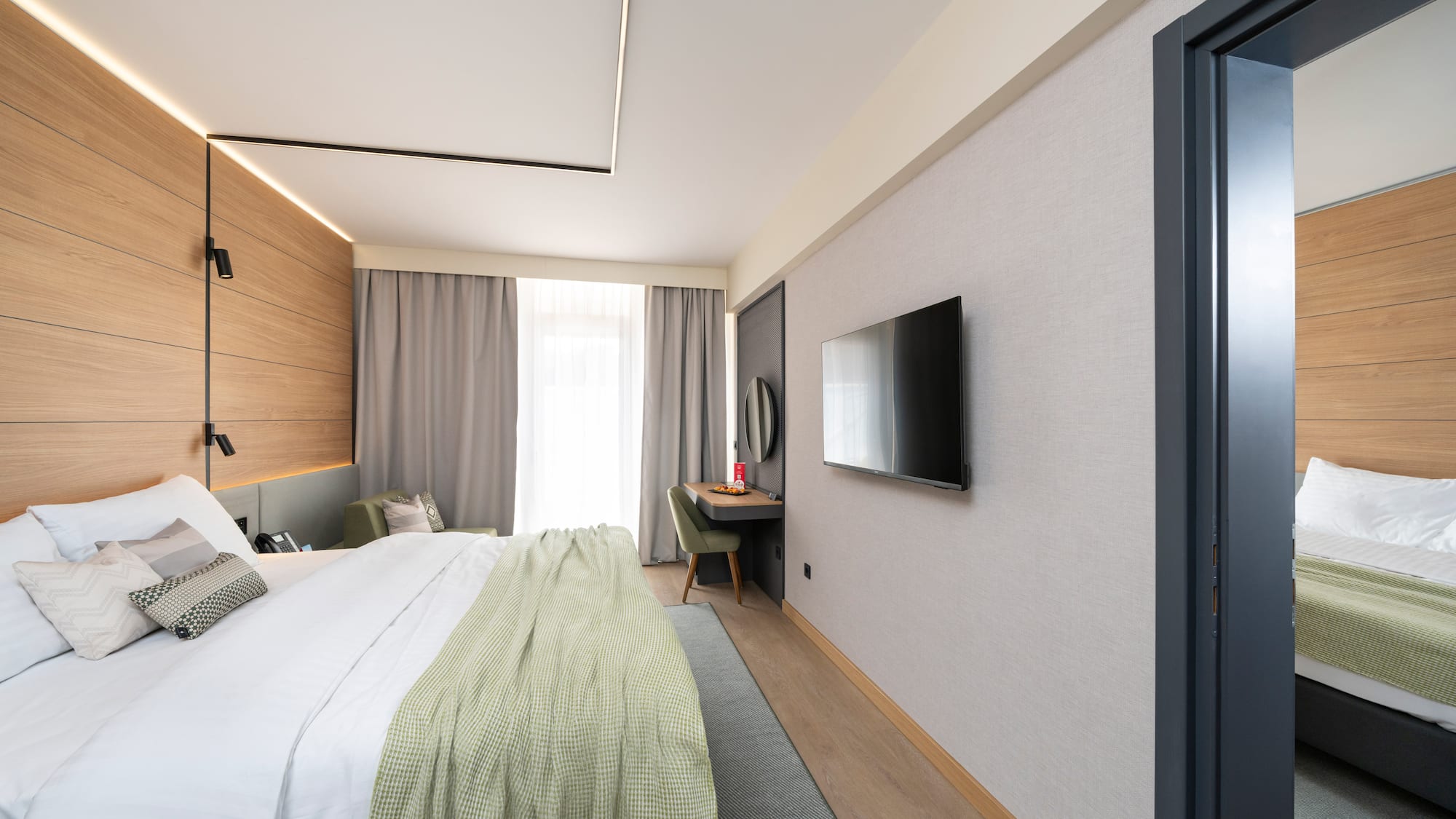 a bedroom with a tv and a bed