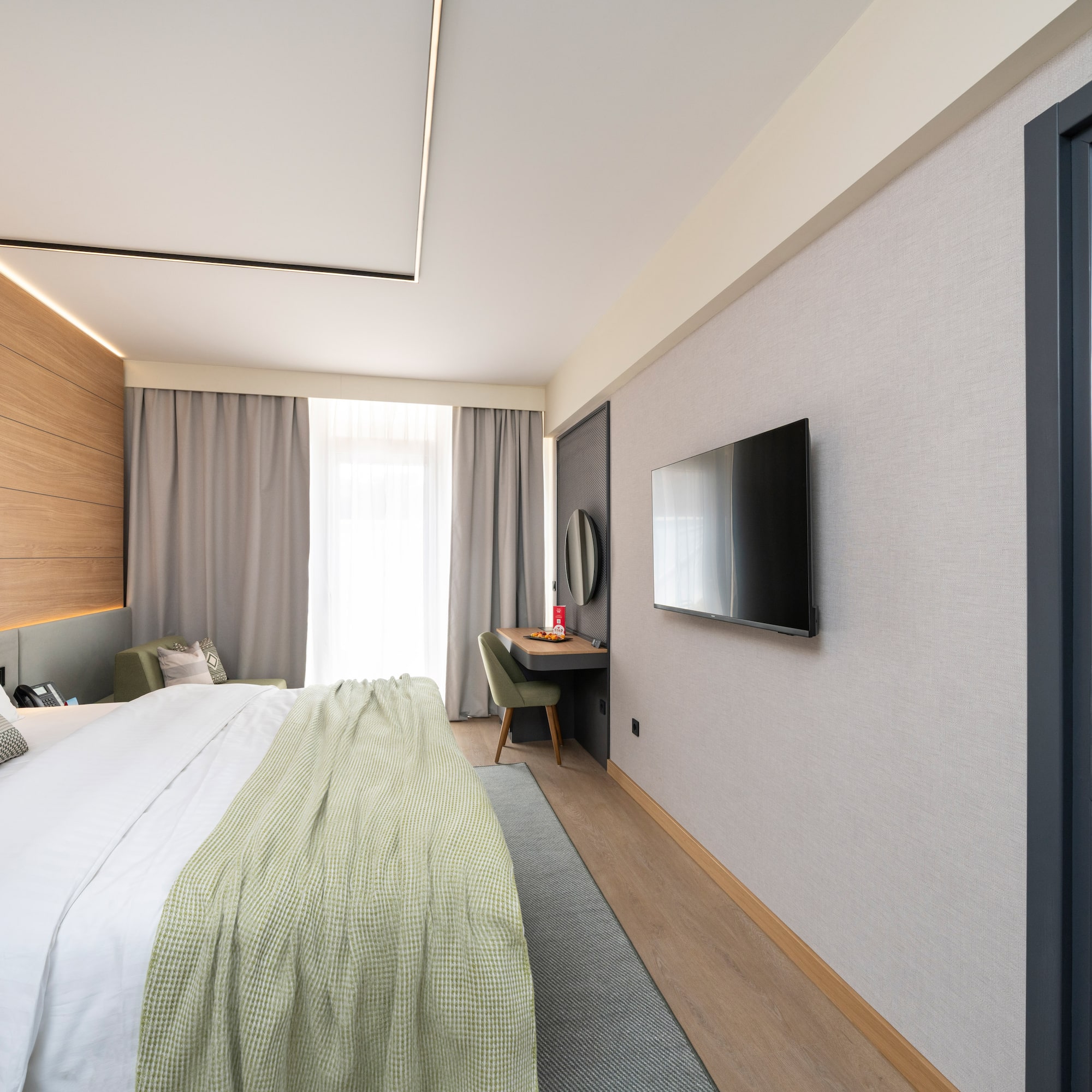 a bedroom with a tv and a bed