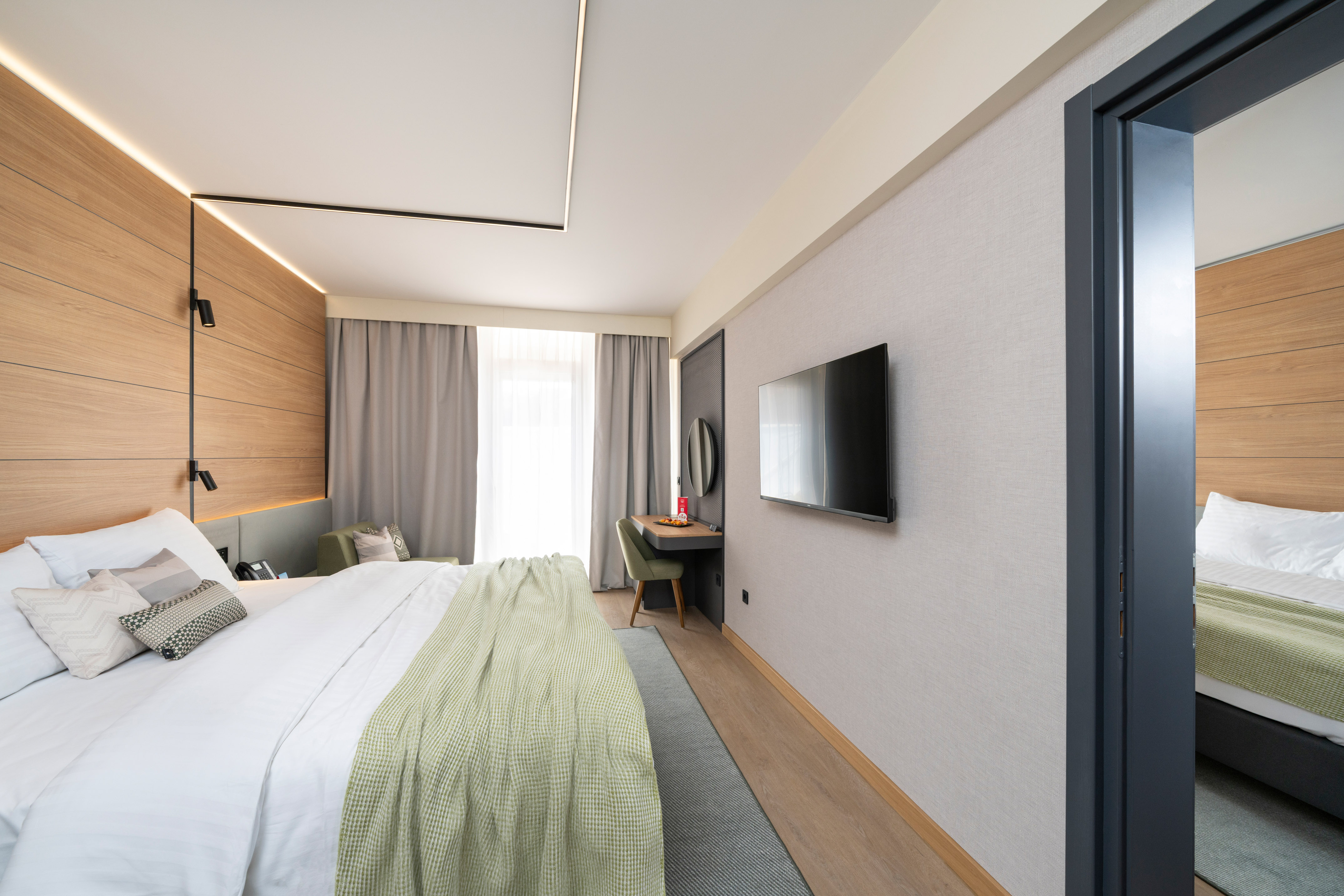a bedroom with a tv and a bed